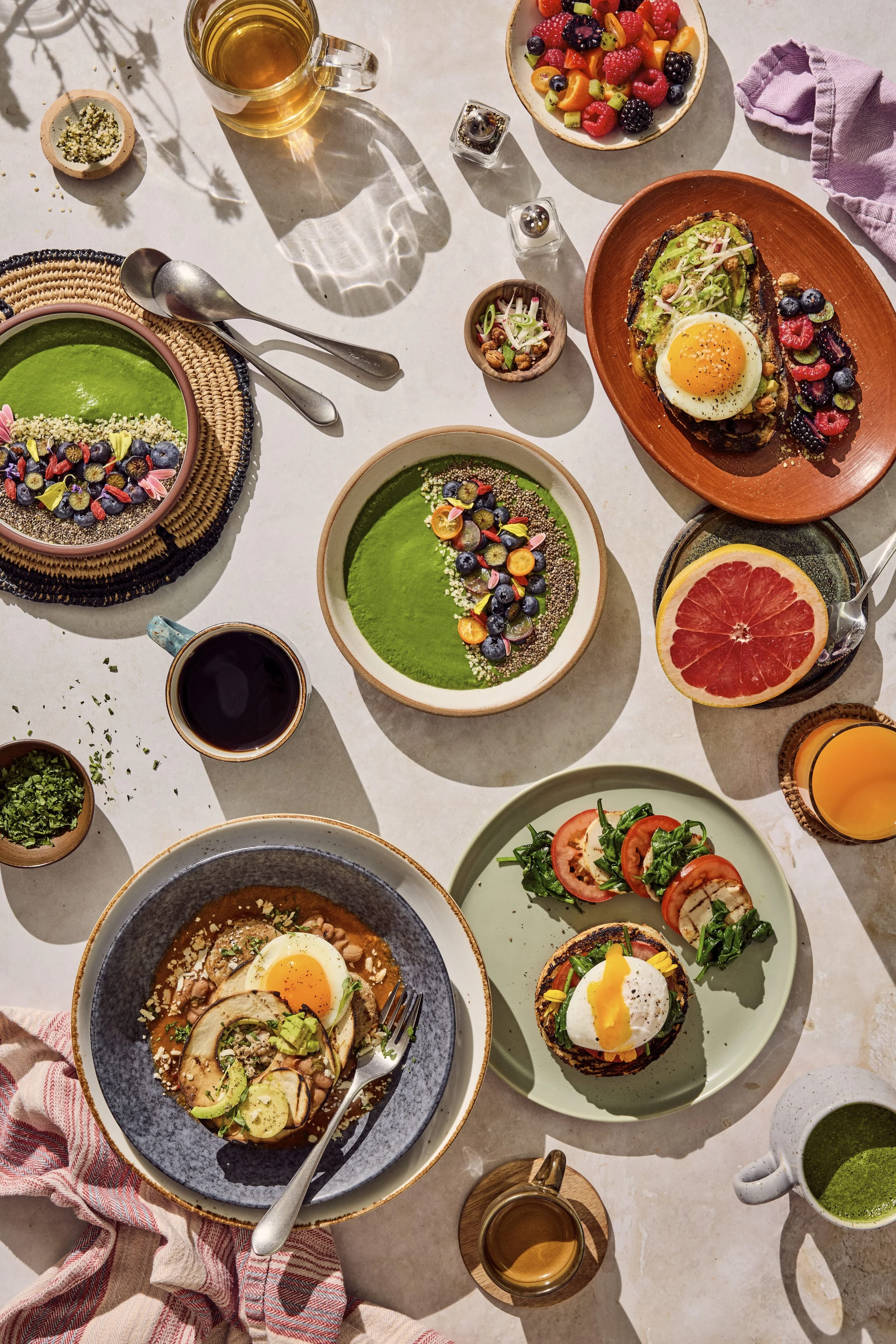 Healthy breakfast tablescape including parfaits, fresh grapefruit, avocado toasts, and egg benedicts. Prop styling by Audrey K. Davis. Food by Chef Pete Ghione. Image by Austin-based food and lifestyle photographer, Mackenzie Smith for Canyon Ranch.