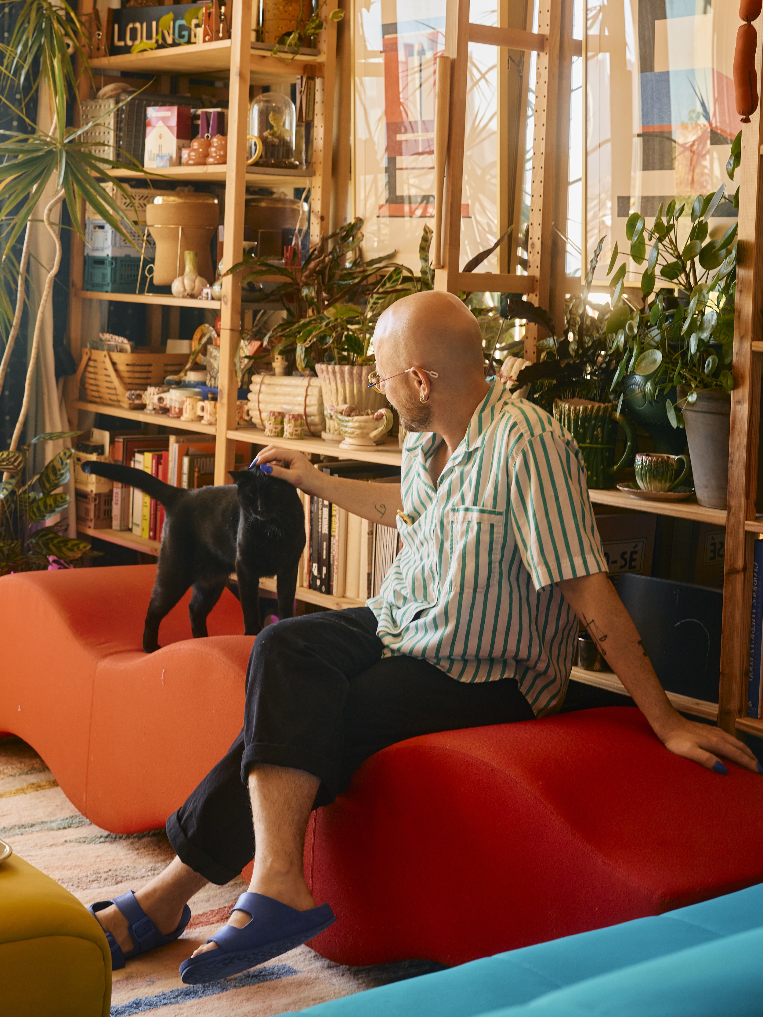 Zach and Louie the cat in their living room in Houston, TX. Image by Austin-based lifestyle photographer, Mackenzie Smith.