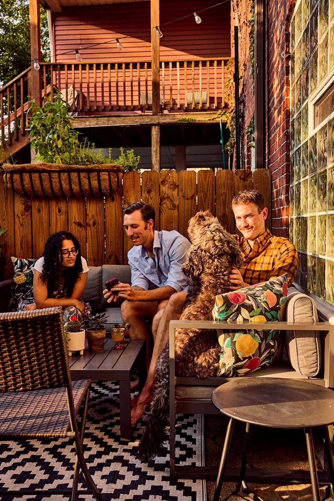 Alexander and Bobby entertaining guests on their back patio of their townhome. Image by Austin-based lifestyle photographer, Mackenzie Smith.