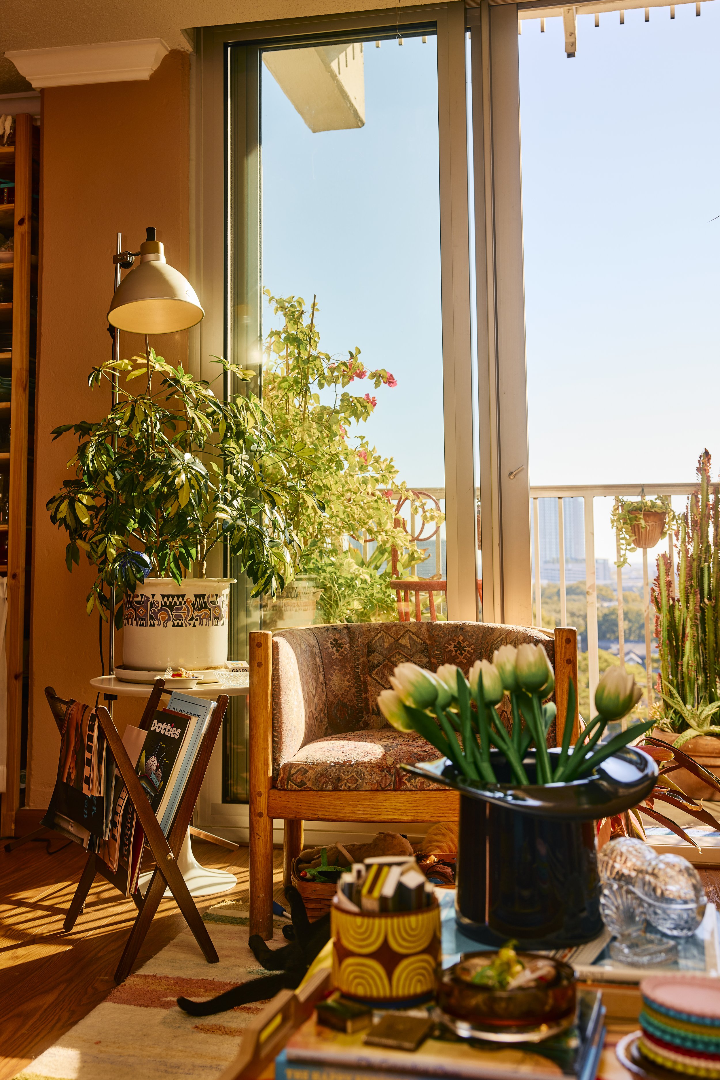 Large windows open to a small patio in this apartment in Houston, TX. Image by Austin-based lifestyle photographer, Mackenzie Smith.