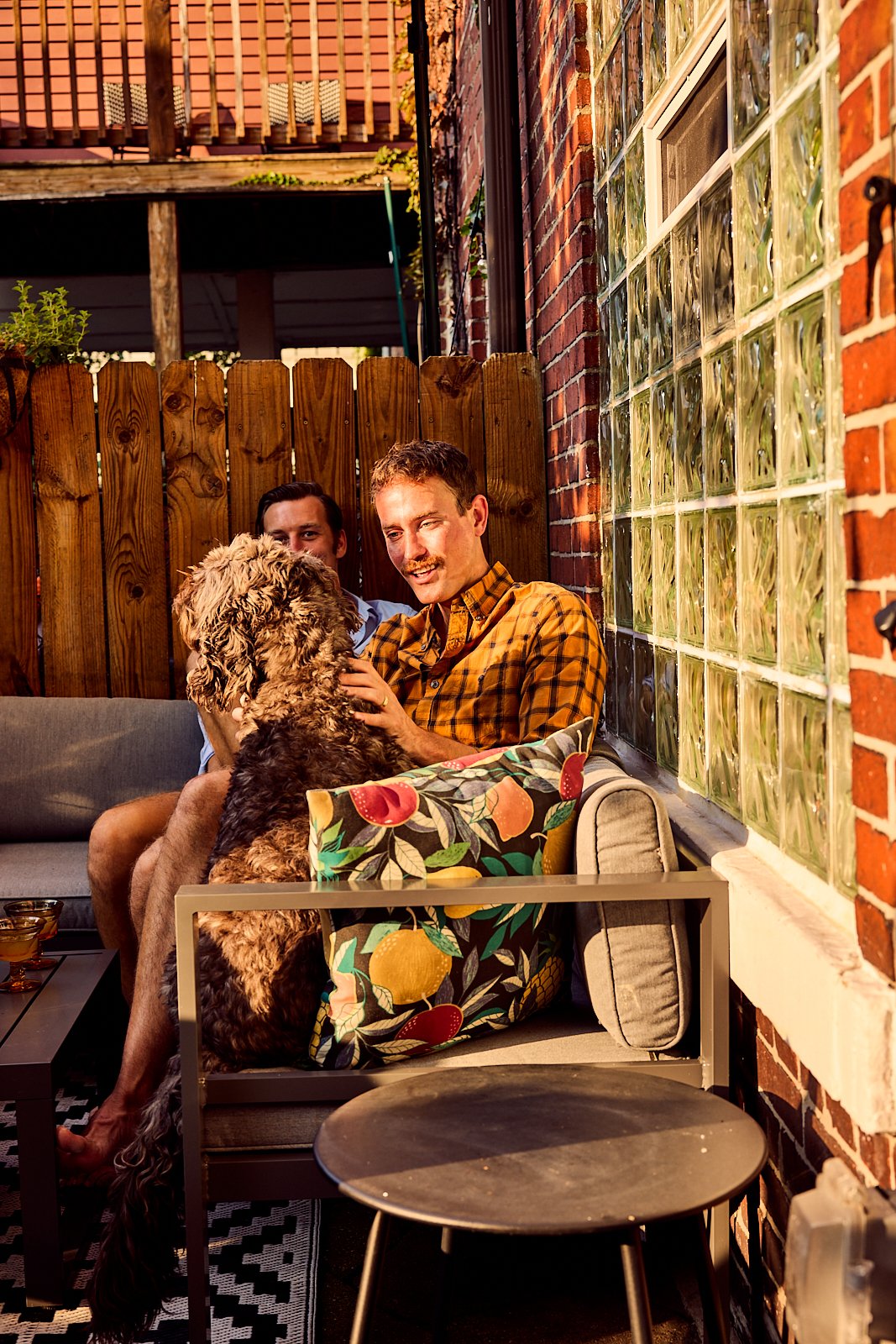 Alexander, Bobby, and their dog on the back patio of their townhome. Image by Austin-based lifestyle photographer, Mackenzie Smith.