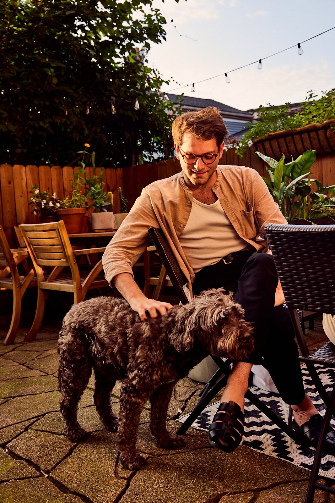 Bobby Naugle and his dog in the backyard of their Pittsburgh, PA townhome. Image by Austin-based lifestyle photographer, Mackenzie Smith.