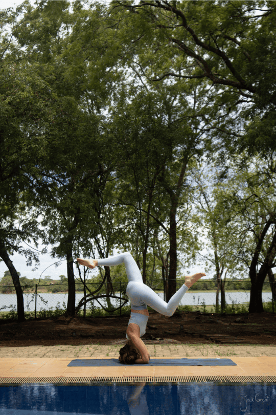 Issy Luck doing yoga at Tranquil Wild Swimming Pool.png
