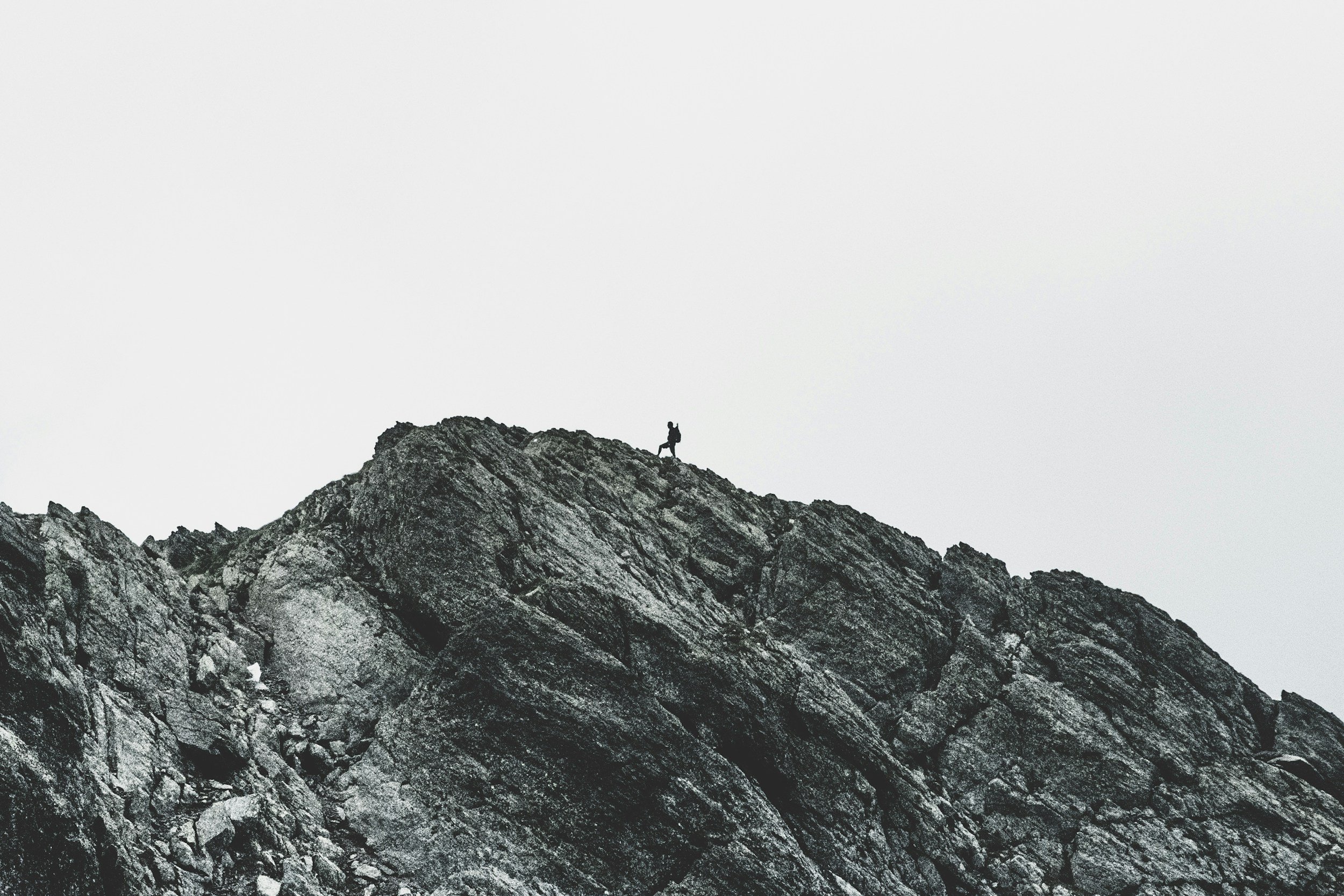 Man scaling a mountain