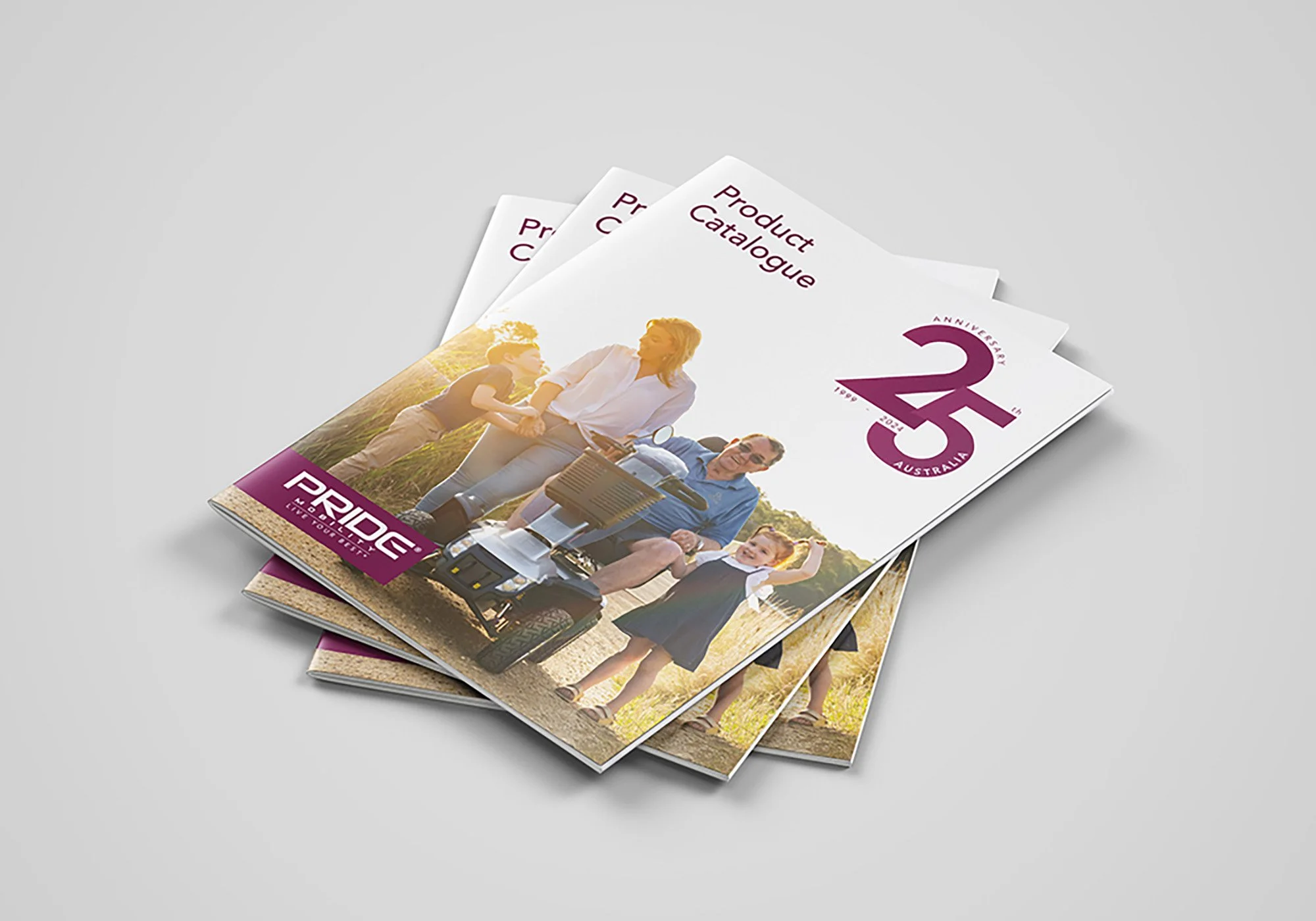 Three brochures for Pride Australia’s 25th anniversary, featuring a family outdoors, with a woman, two children, and an elderly man on a mobility scooter on the cover.