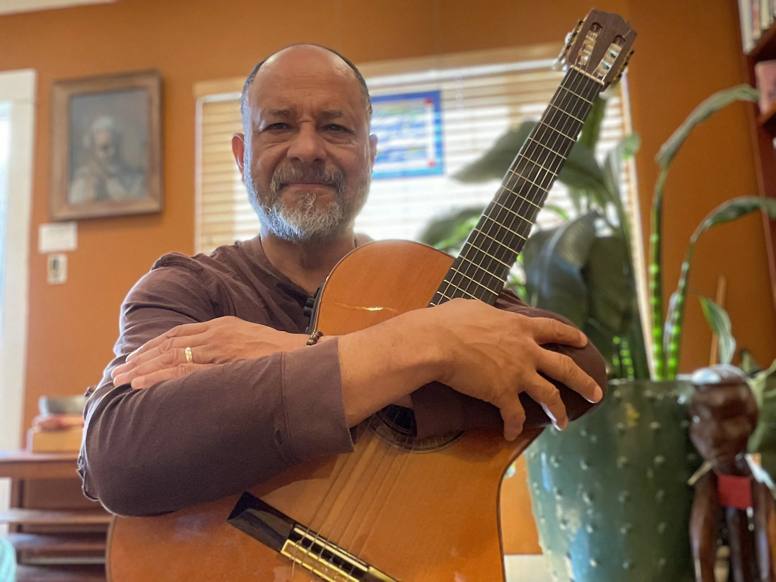 Curtis Robertson Jr. musician holding acoustic guitar