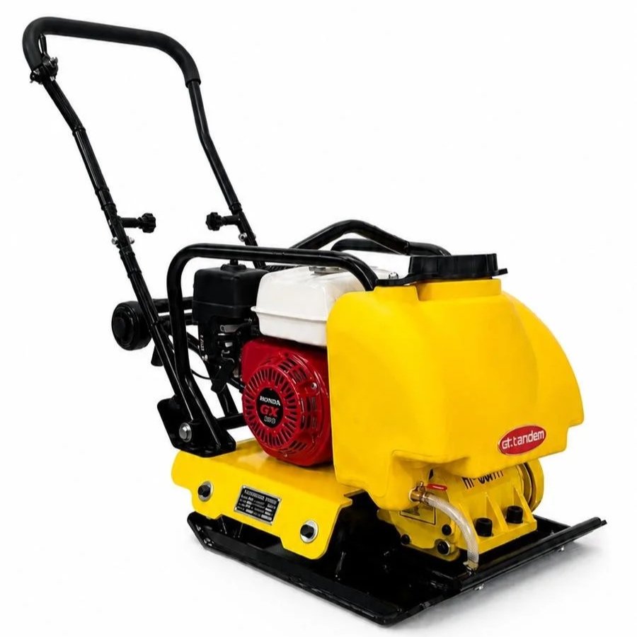 A yellow vibratory plate compactor with a red Honda GX engine and black handlebar.