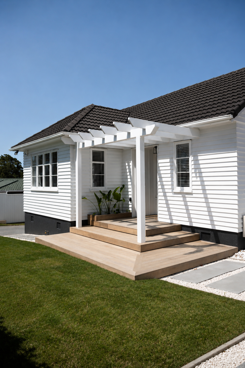 Custom timber deck and pergola creating a welcoming outdoor living space with clean lines, landscaped lawn, and modern garden detailing.