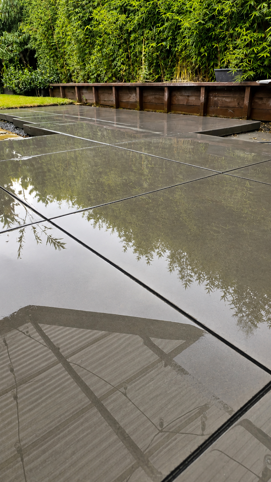 Large-format honed concrete patio with clean saw-cut joints, creating a modern outdoor living space.