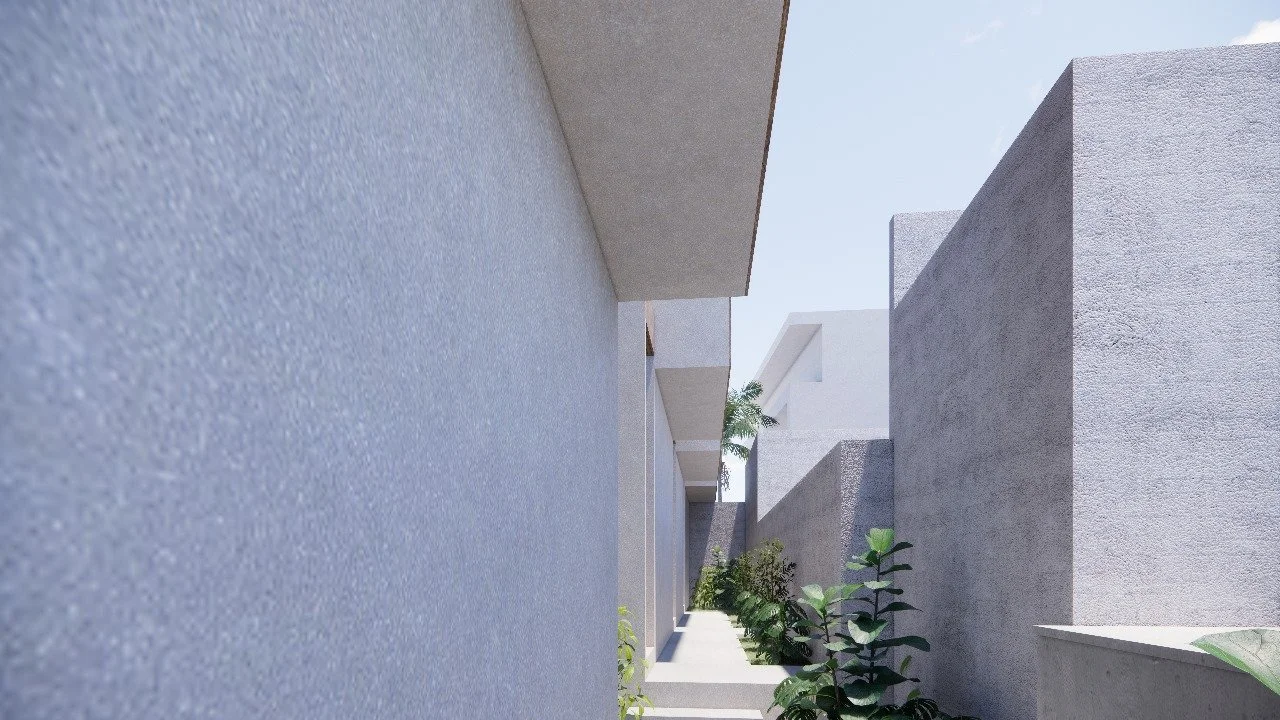 A modern outdoor walkway with concrete walls and greenery, captured on a sunny day.