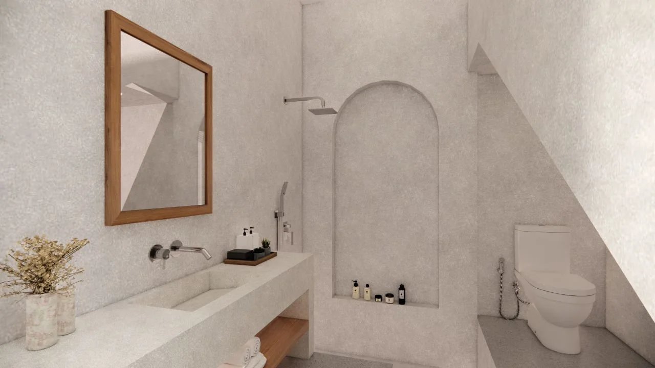 Minimalist bathroom with white textured walls, a large rectangular mirror with a wooden frame, a white sink with wall-mounted faucets, a small tray holding soap dispensers and a plant, a shower area with a rain showerhead, and a white toilet under a 