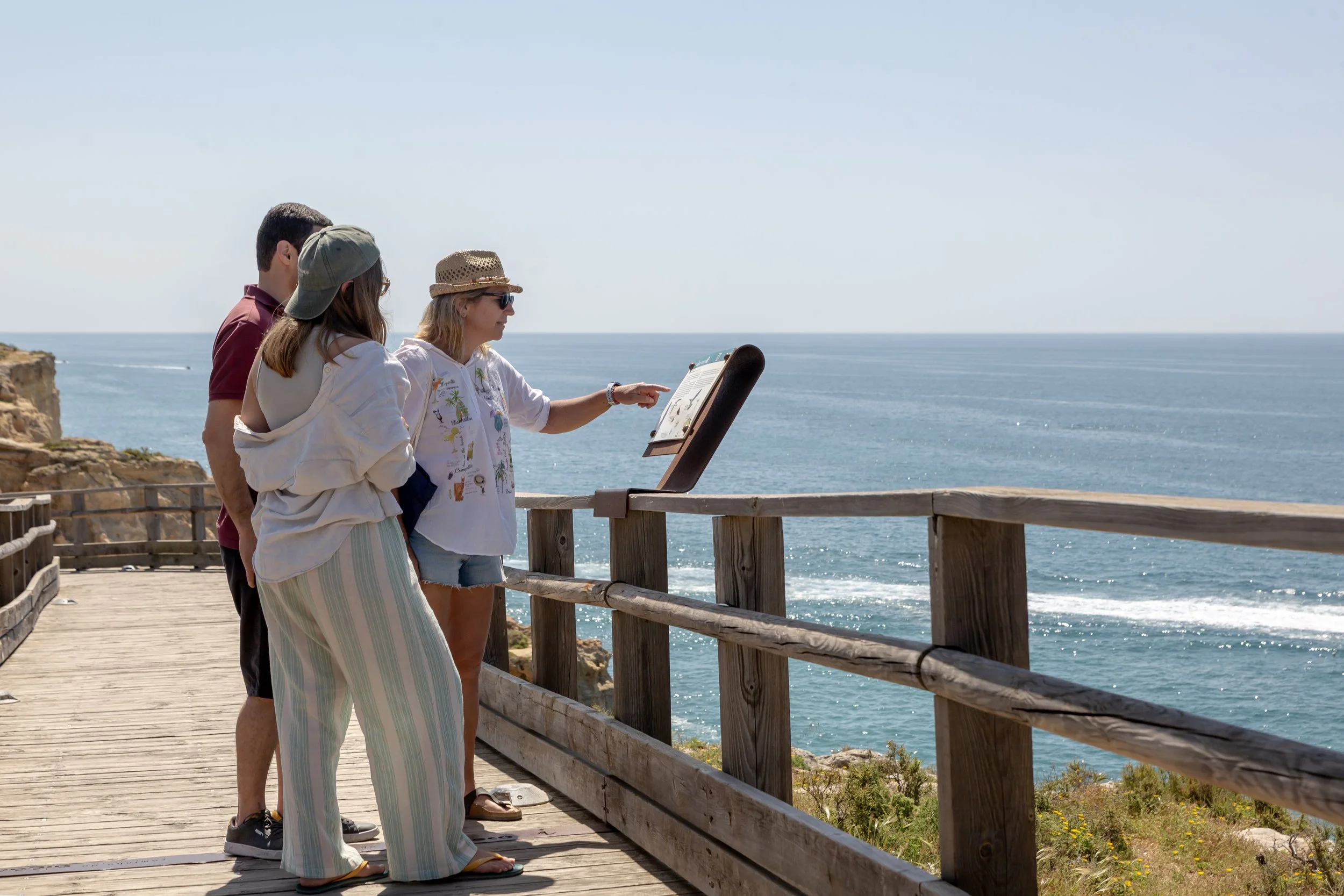 Three people enjoying Carvoeiro boardwalk