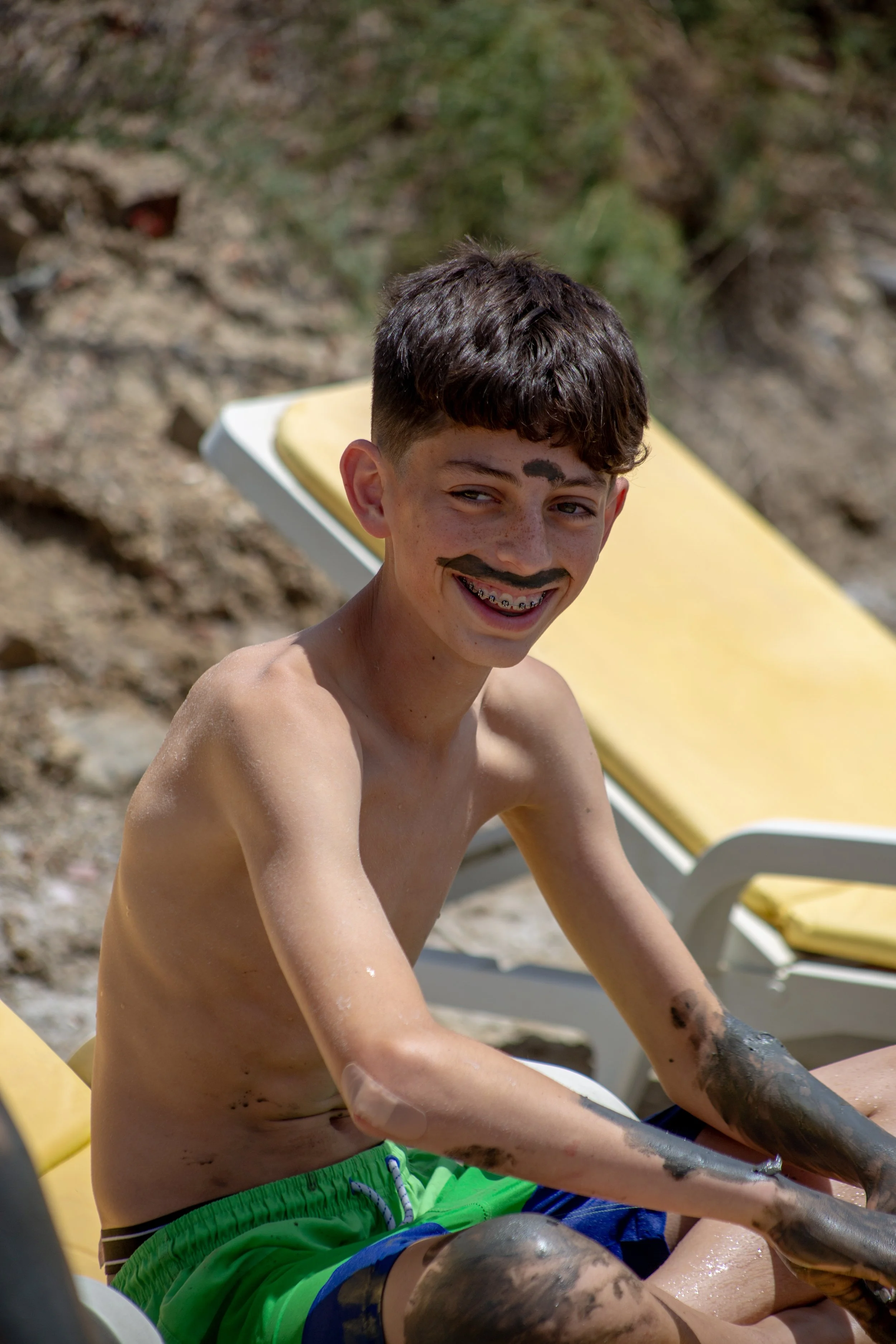 Teenager having fun in salt spa in Castro Marim