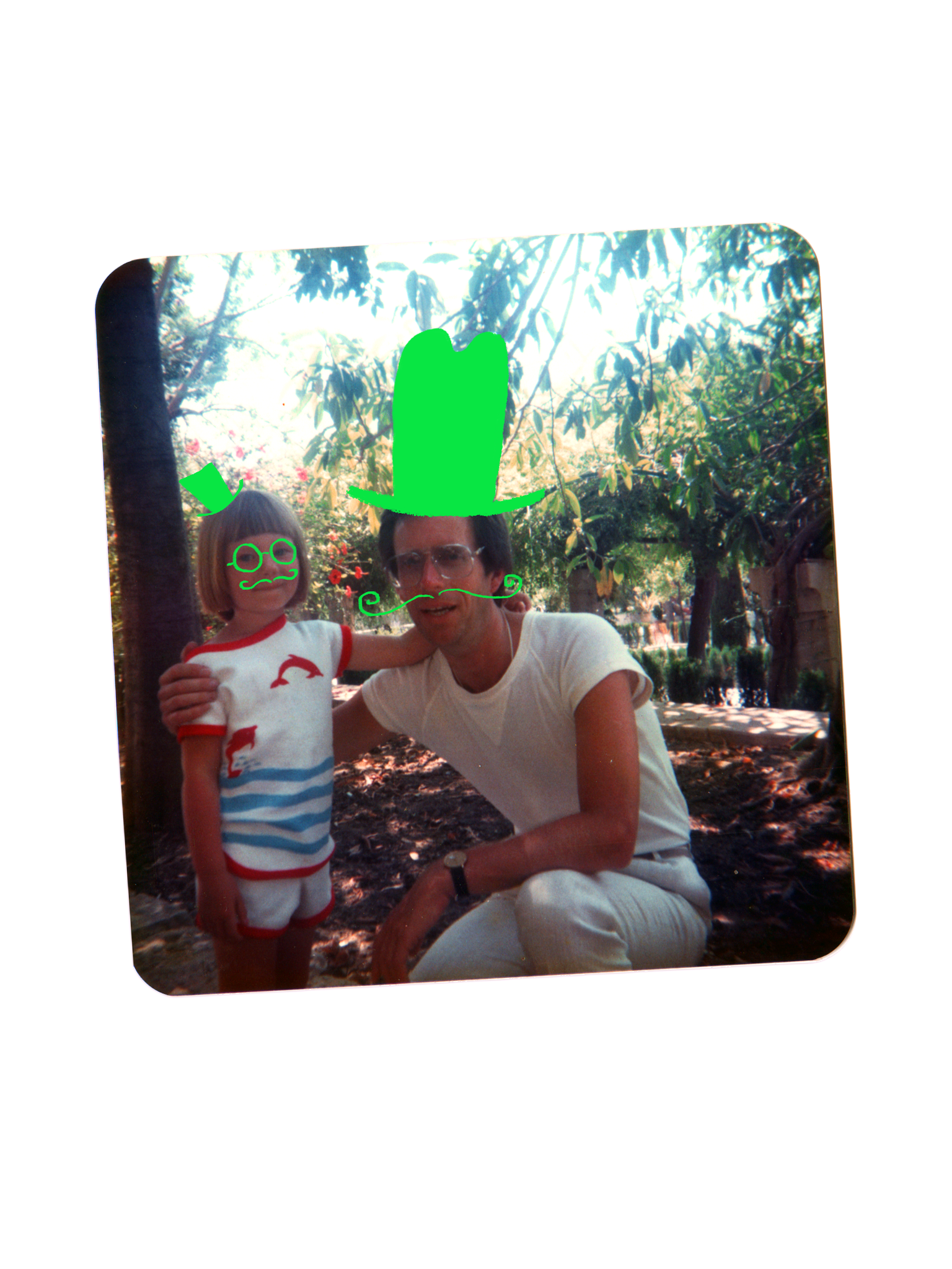 A young girl with short hair and glasses standing next to a man with glasses in a park, with green doodles including a top hat, mustache, and eyes drawn on the photo.