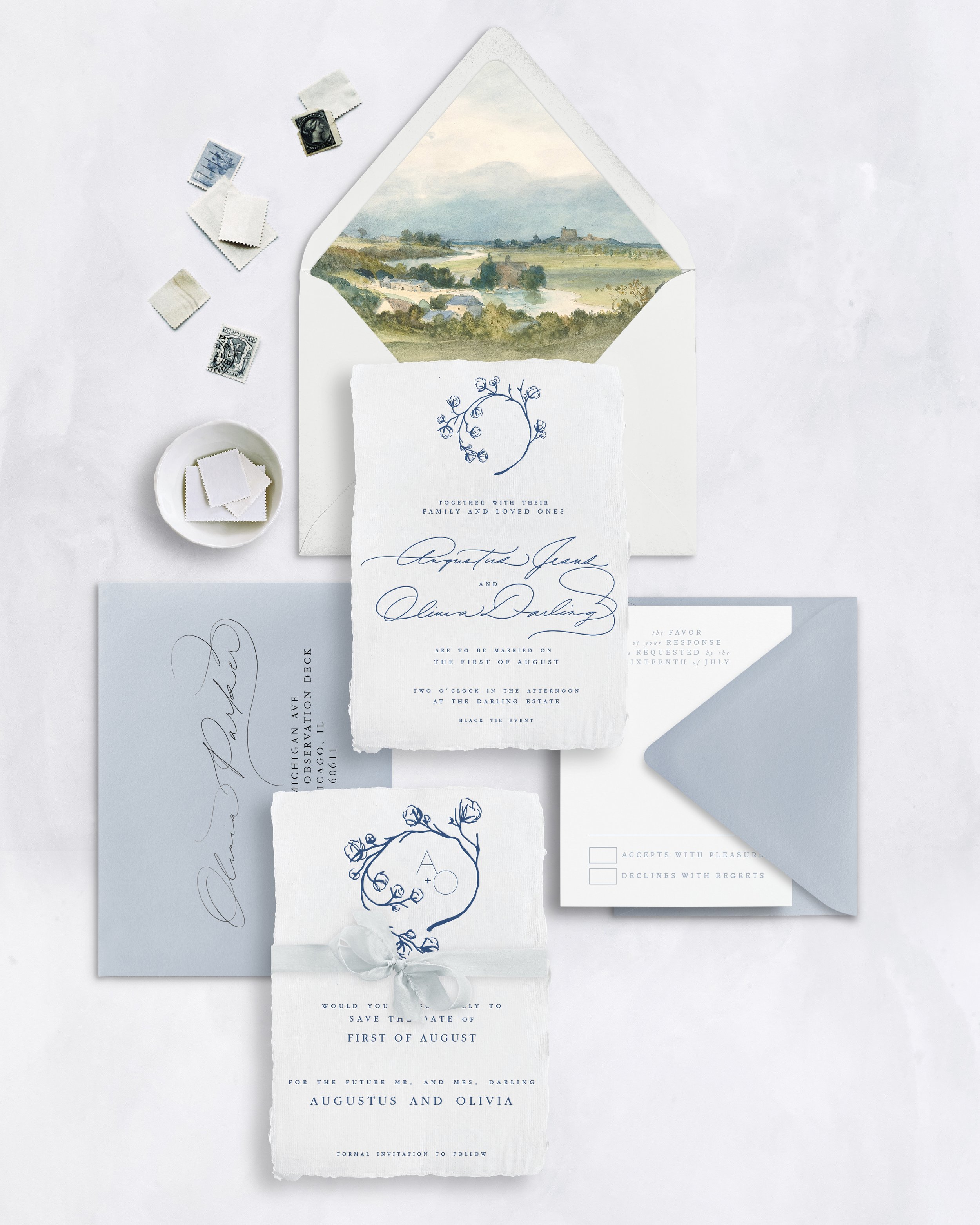Wedding invitation suite with RSVP card, save-the-date card, postage stamps, and a landscape painting inside an envelope on a white background.