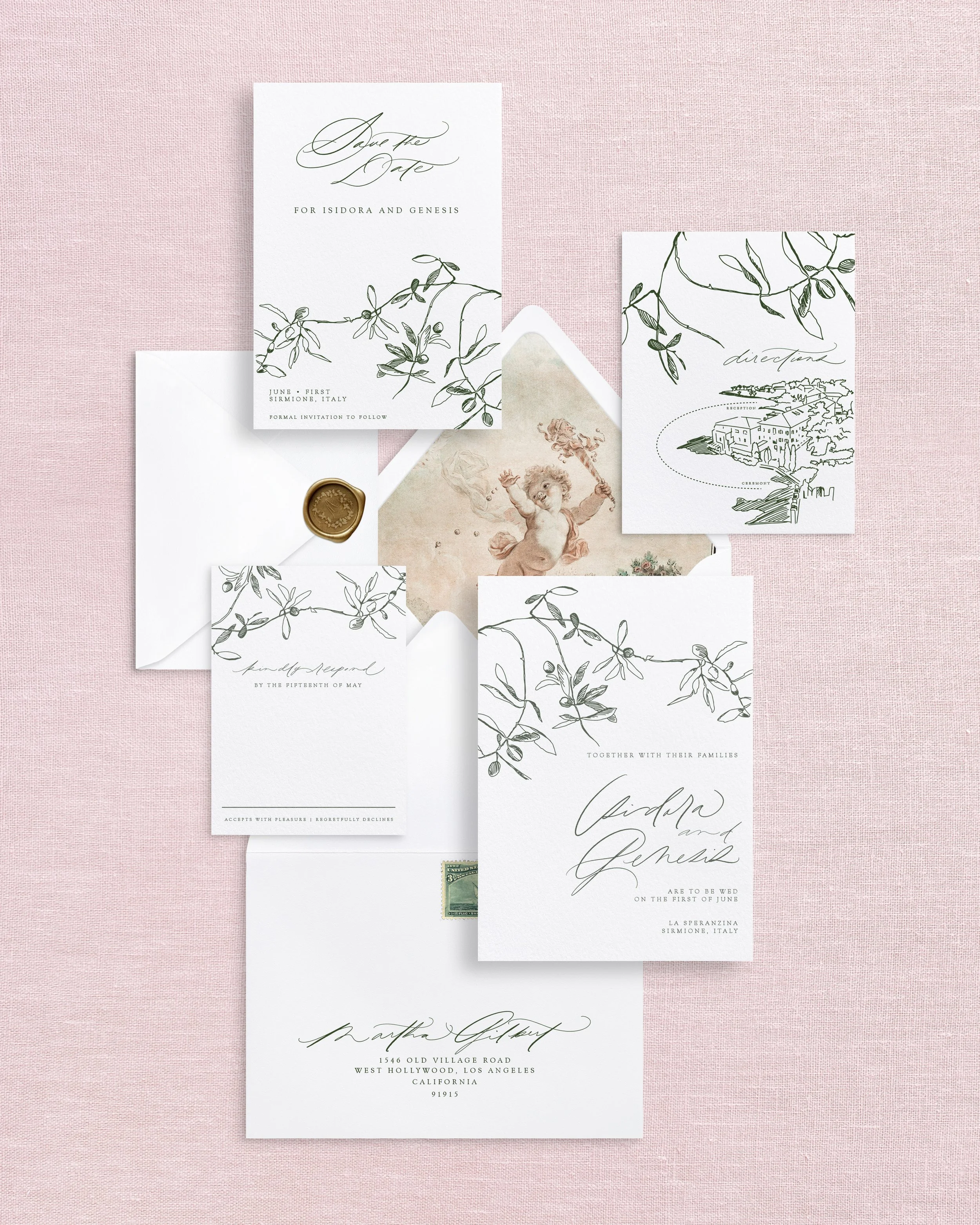 A wedding invitation with a landscape painting, a white ribbon, and a card with floral sketch, surrounded by postage stamps and a small dish of stamps on a white background.
