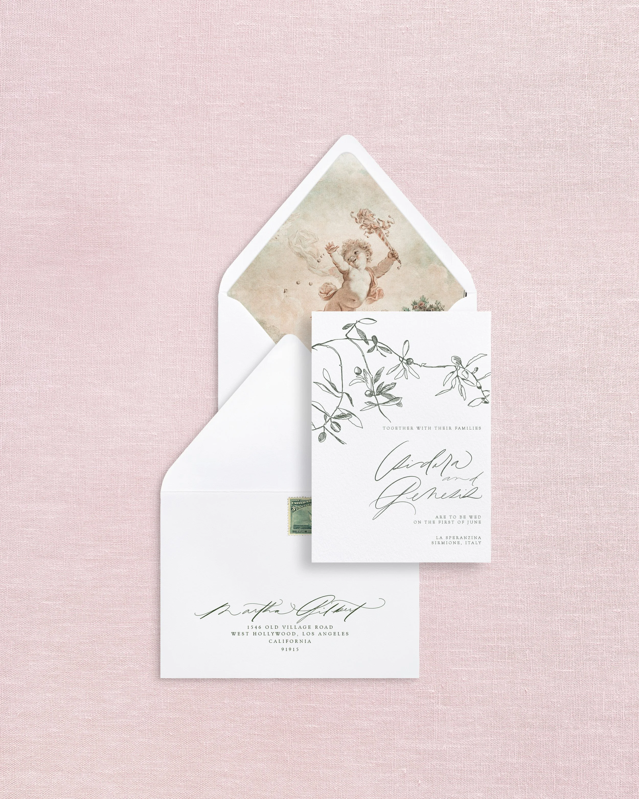 Invitation and wedding stationery set with blue and white designs, envelopes, stamps, and a save-the-date card for August 1st wedding of Augustus and Olivia.