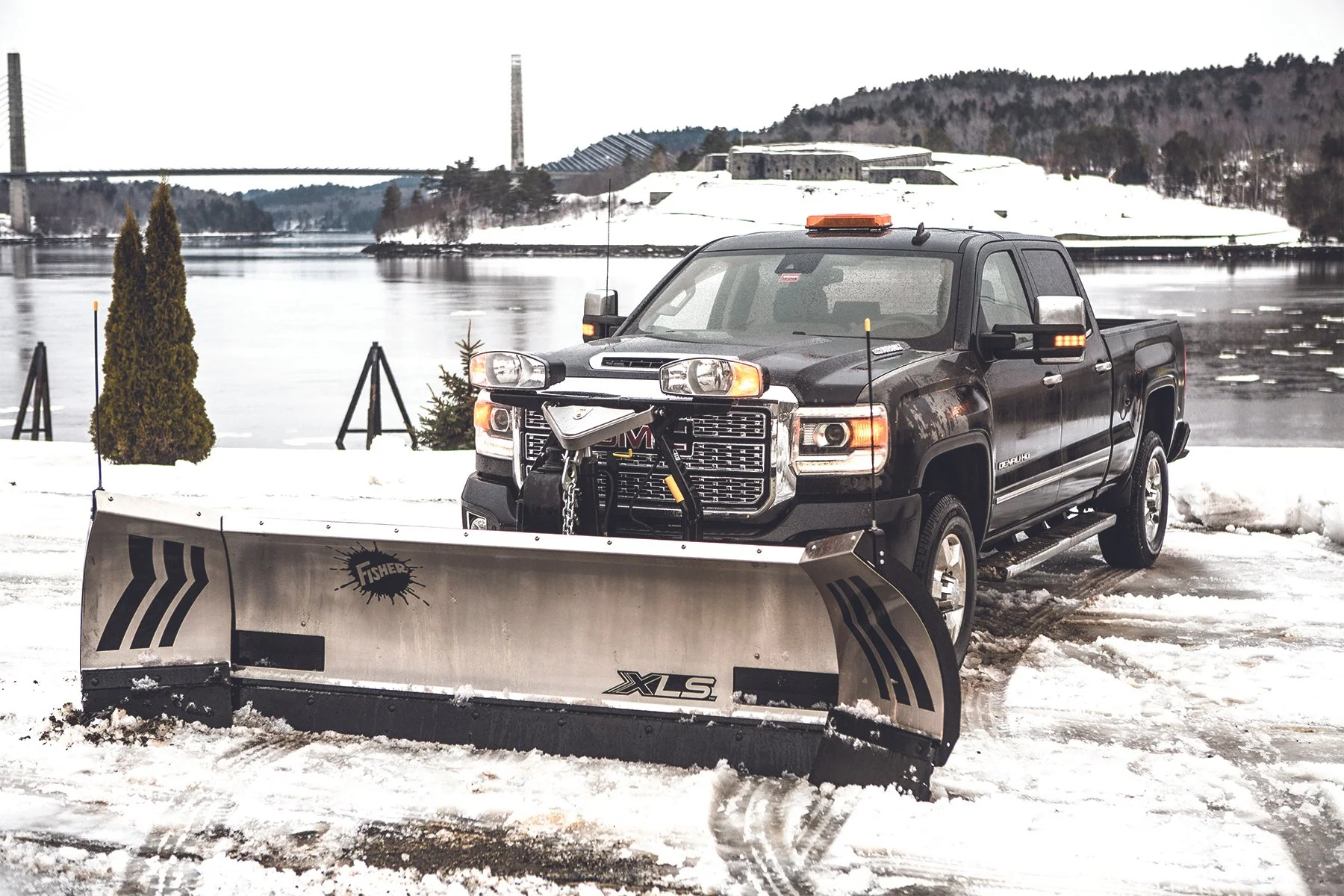 Hero shot of a Stainless Steel Fisher XLS with Halogen Lights attached to GMC 3500 Truck
