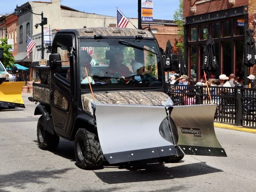 SnowDogg VUT65 attached to a Kobota UTV driving through parade