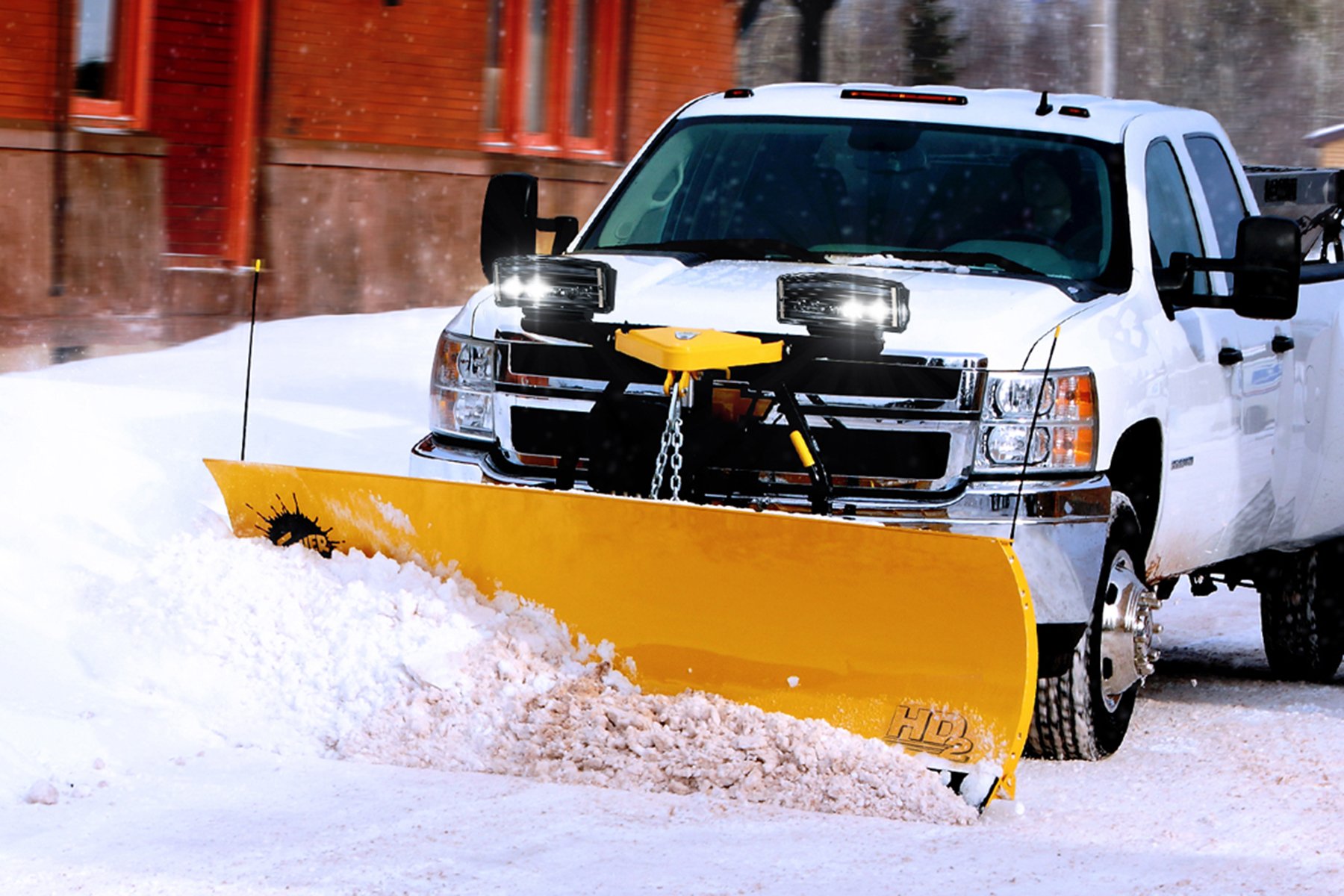 Hero Shot of a Fisher HD2 snow plow with LED lights attached to Chevy 3500 Truck