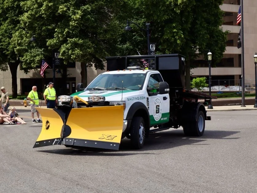 Fisher XV2 Snow plow with halogen lights attached to Ford F550 driving in parade