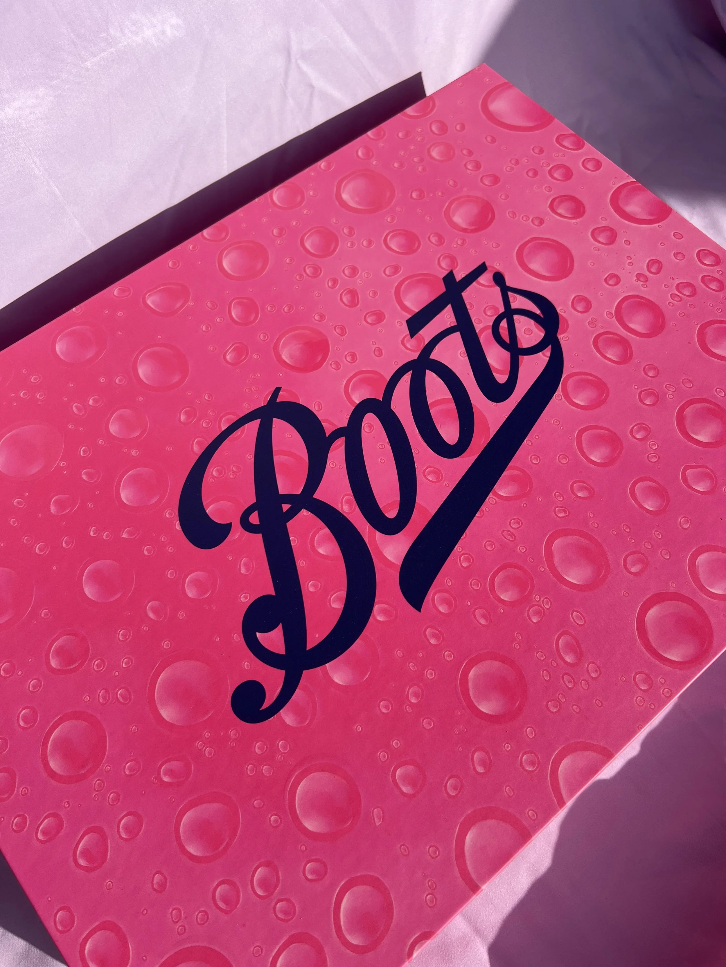 Pink box with a pattern of bubbles and the word 'POP' written in large, stylized black font.