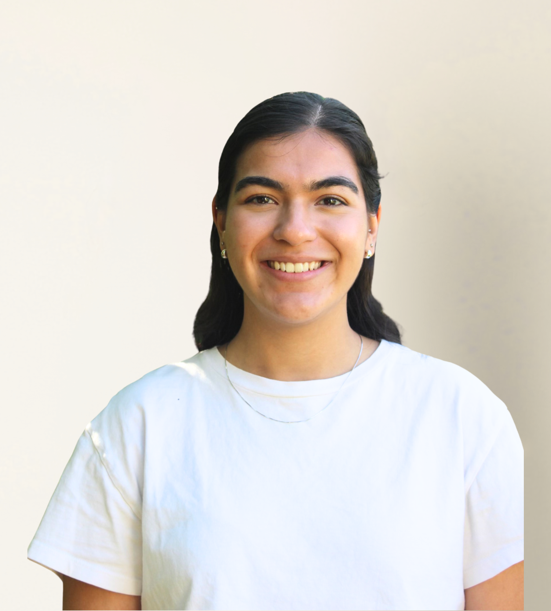 Smiling woman wearing a white t-shirt and small earrings, photographed against a plain light background.