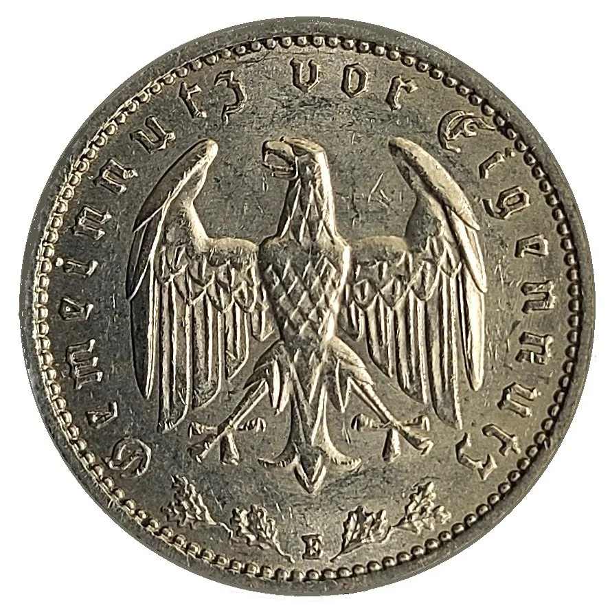 Close-up of a European 20 Deutschmark coin featuring an eagle with outspread wings and the year 1967.
