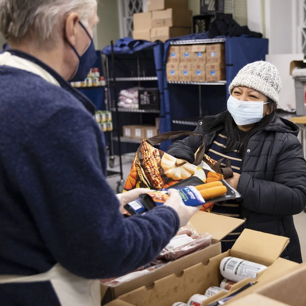 Volunteer at The Pantry helping a visitor