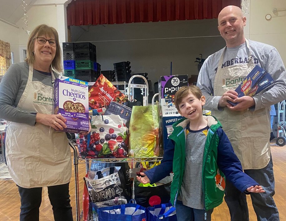 A first grader delivers 263 pounds of food collected by the school for The Pantry in Mount Kisco. Photo courtesy of Bedford Central School District.