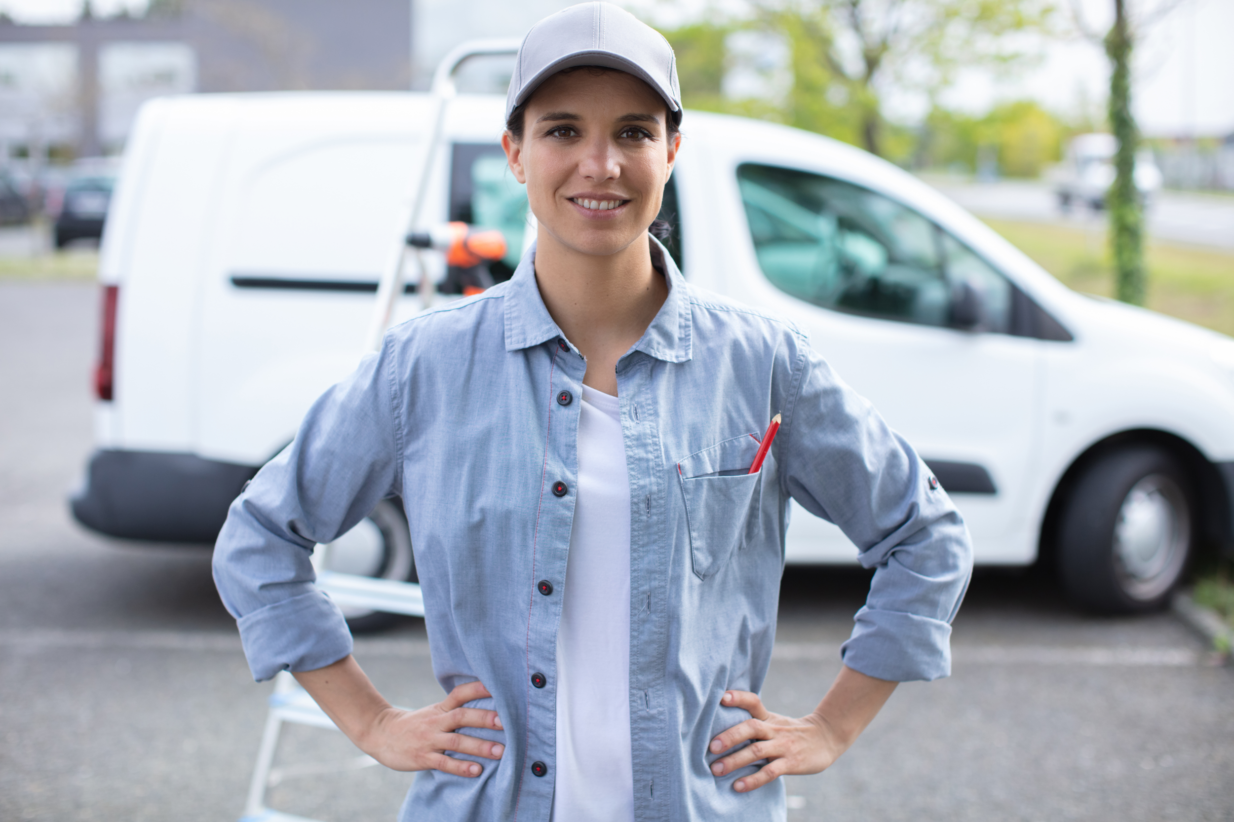 female delivery driver in front of her delivery car