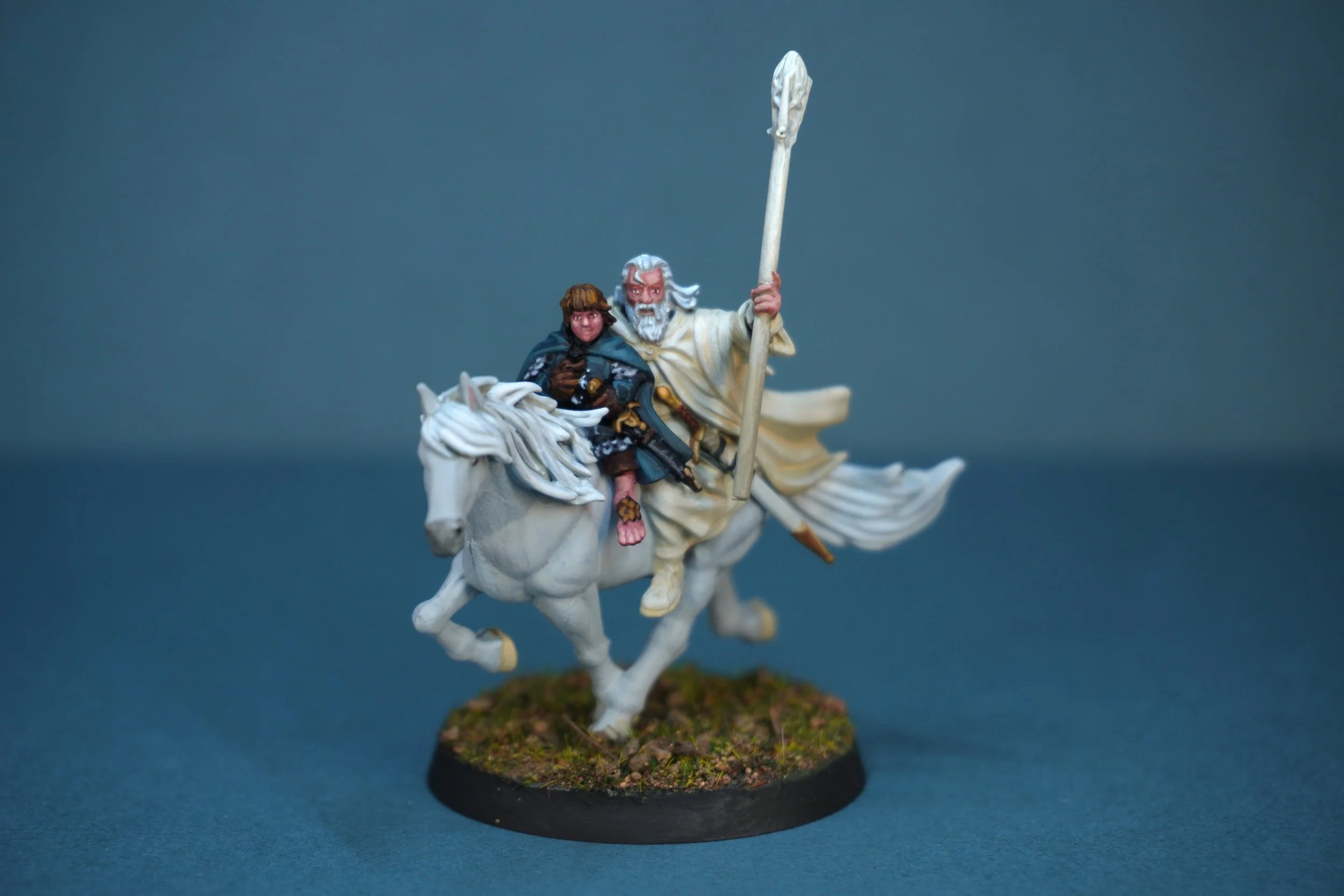 Miniature model of Gandalf the white with Pippin, riding a white horse, holding a tall staff