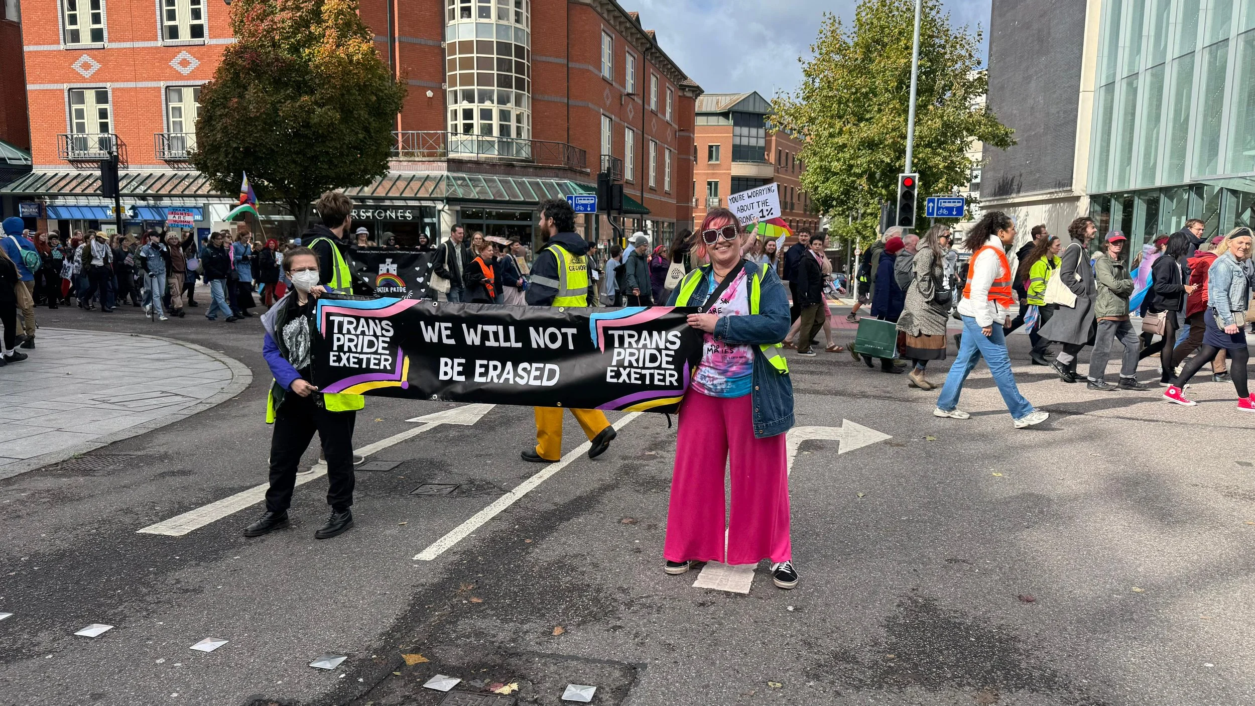 hundreds of marchers go past a temporary road closure