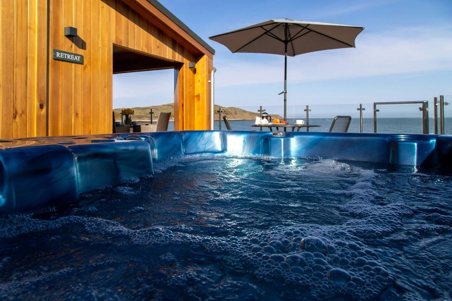 Where we&rsquo;d much rather be in this heat&hellip; ☀️ Soaking up the sun at Rascarrel Bay Lodges&rsquo; Retreat. This stunning side on lodge was customised with a private sauna and hot tub, with uninterrupted sea views across to the Cumbrian hills.