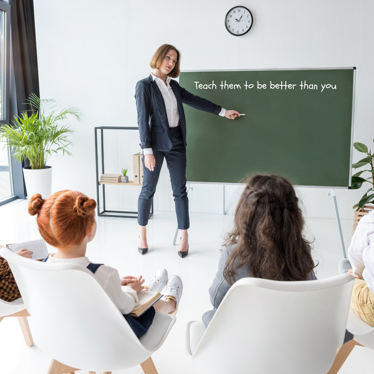 teacher in classroom with a chalkboard