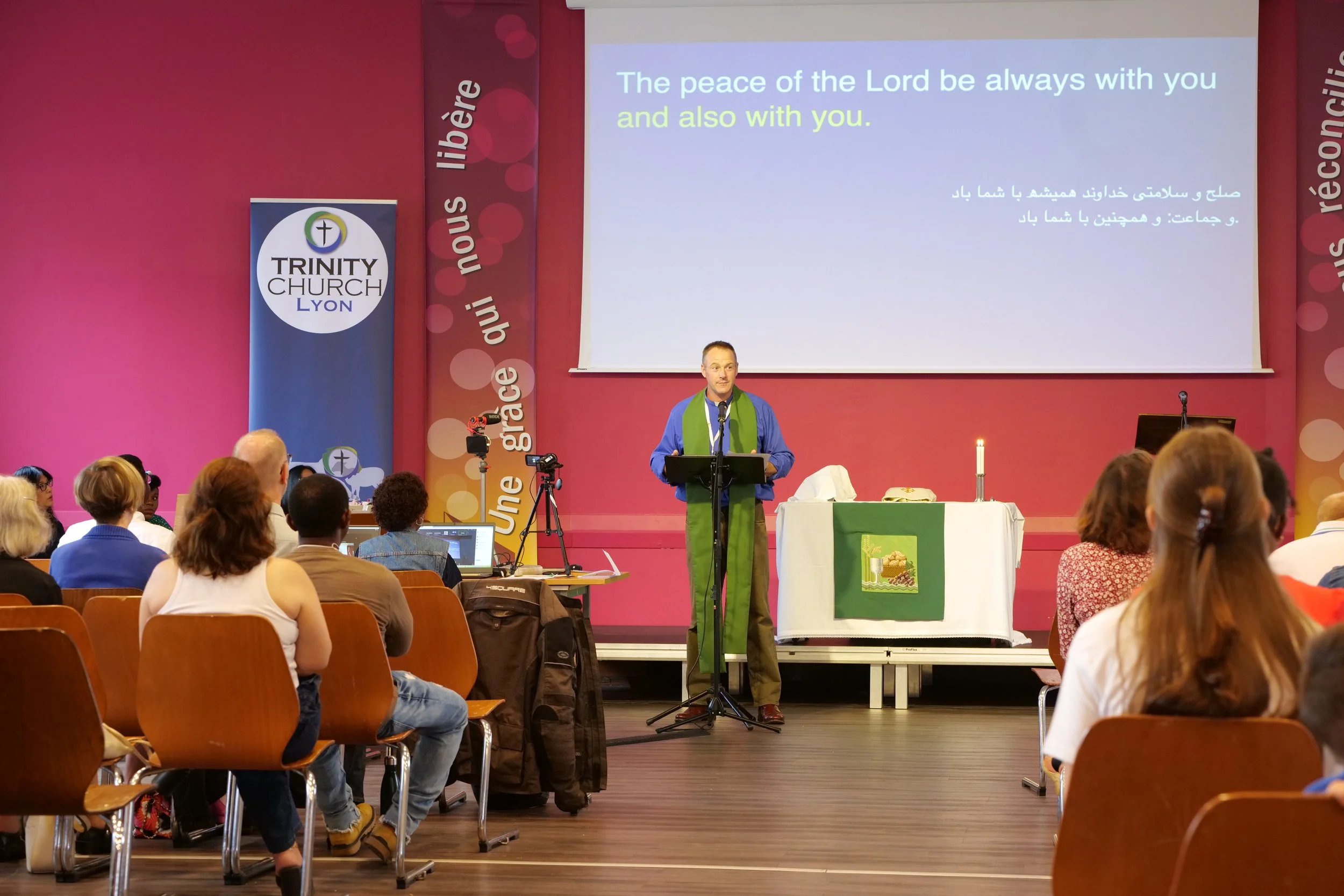 Minister standing at the front of church with congregation listening