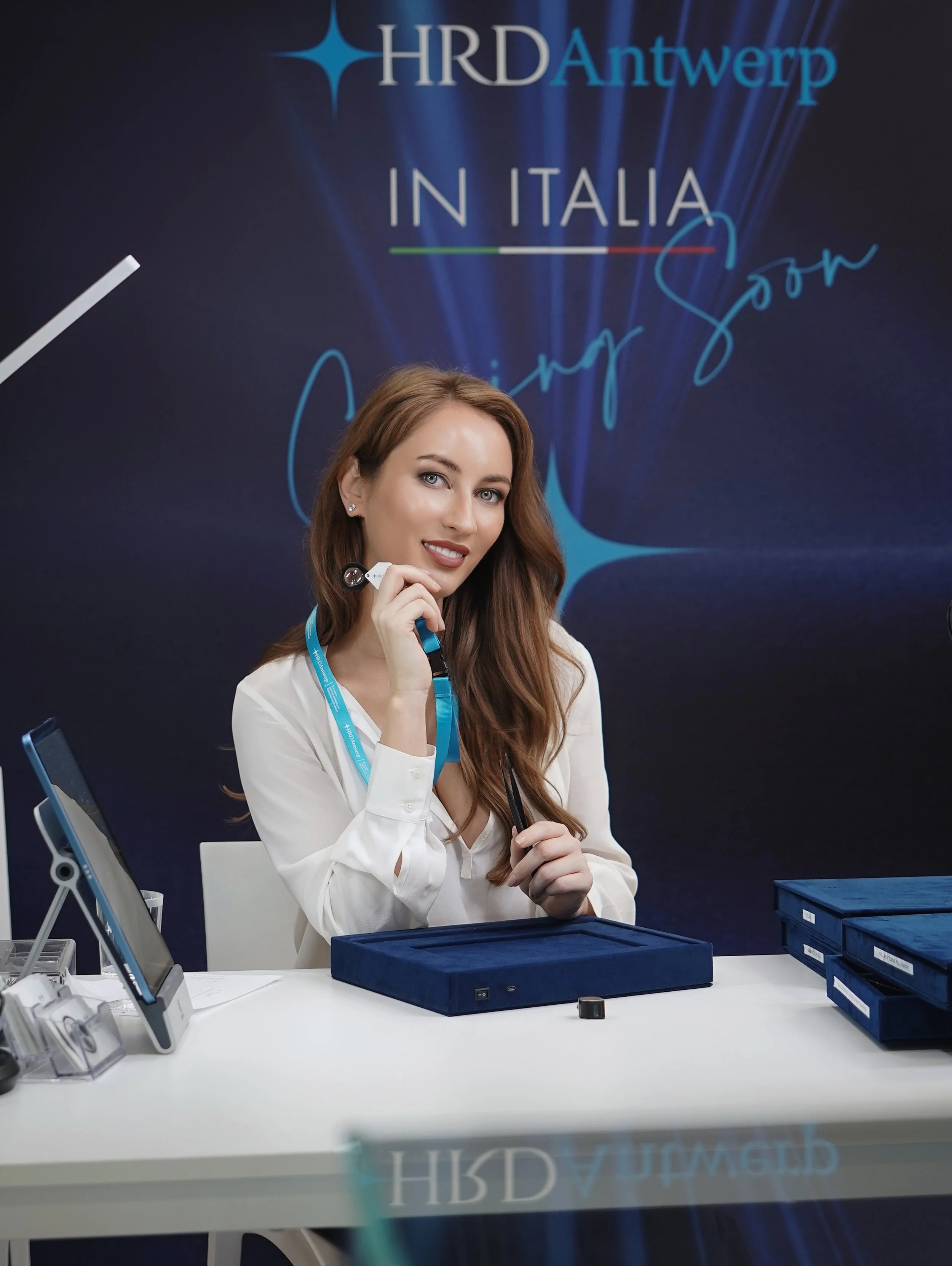 Businesswoman at desk with book signing, personal brand photoshoot New Moon Agency Klagenfurt