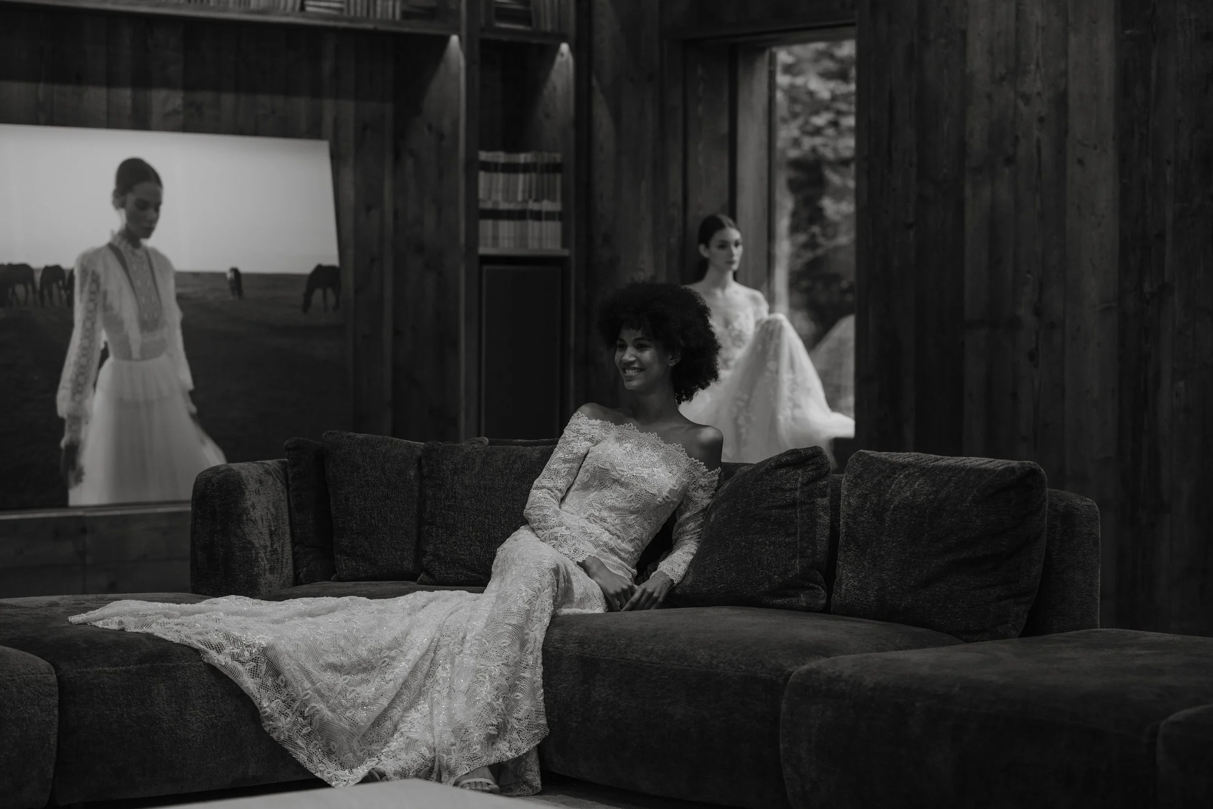 Bride reclining on velvet sofa – timeless fine art moment in architectural interior.