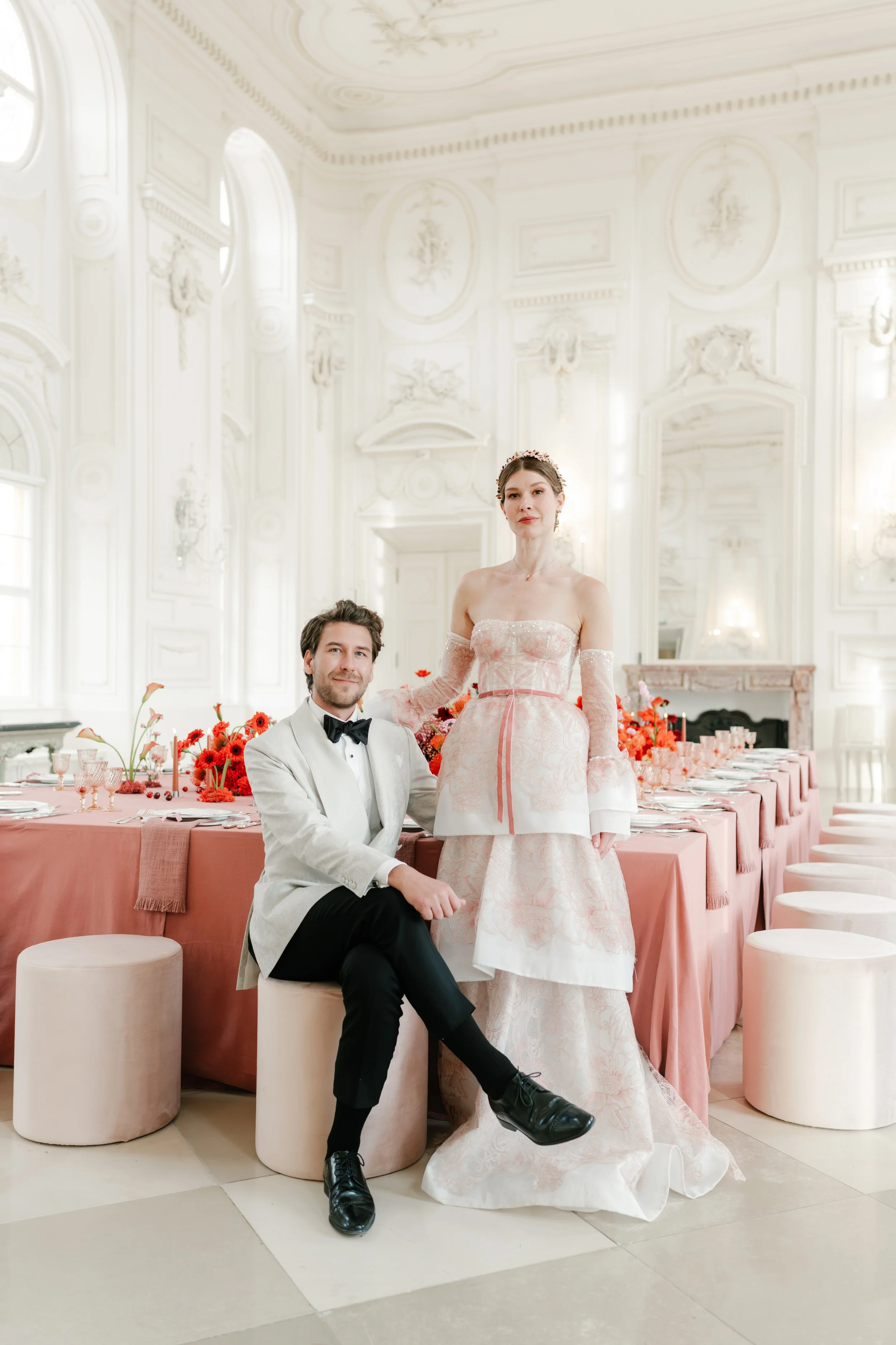 bride and groom are posing at the dinner table