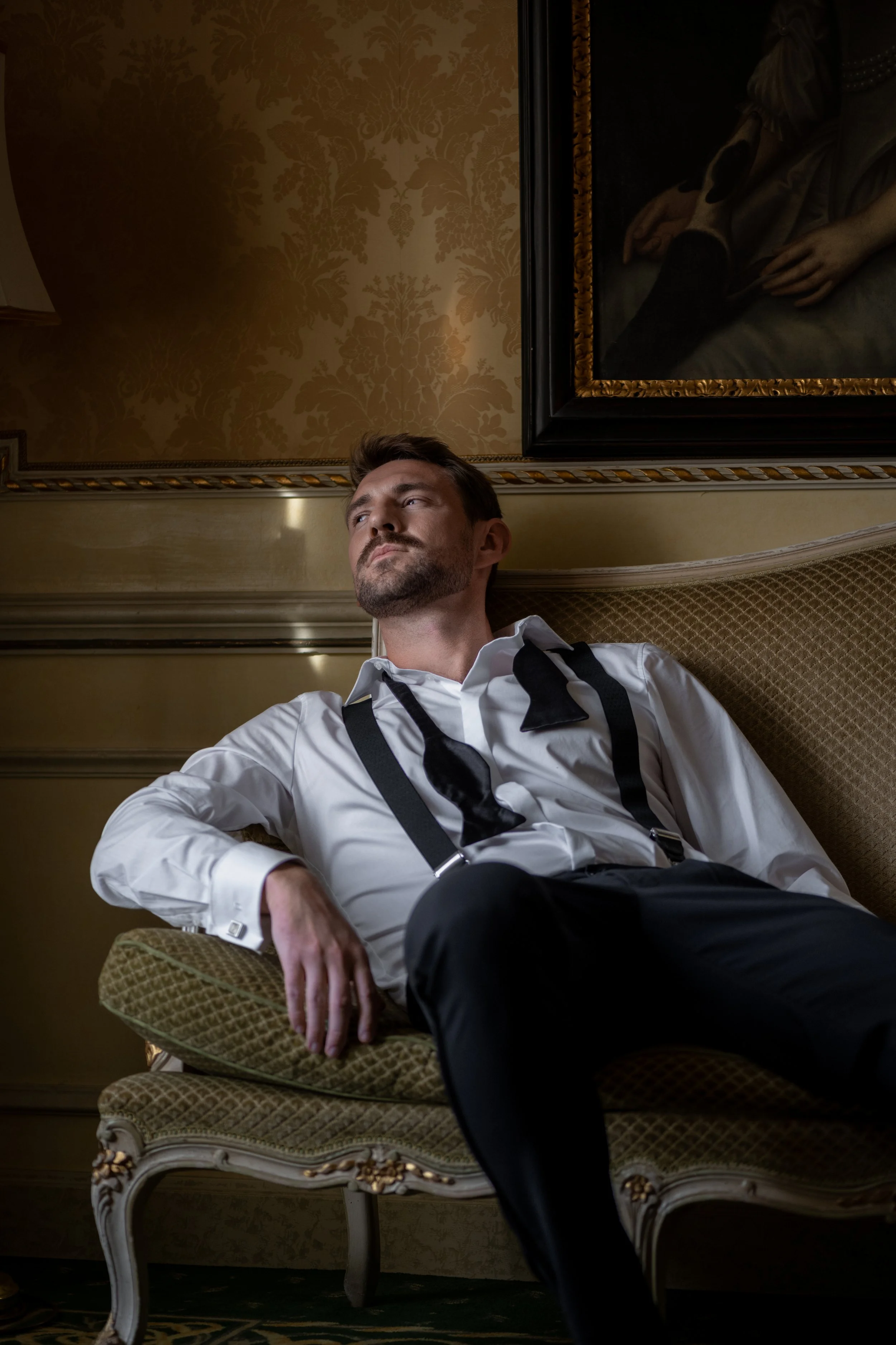 groom waiting in an europian historical luxuryhotel room 