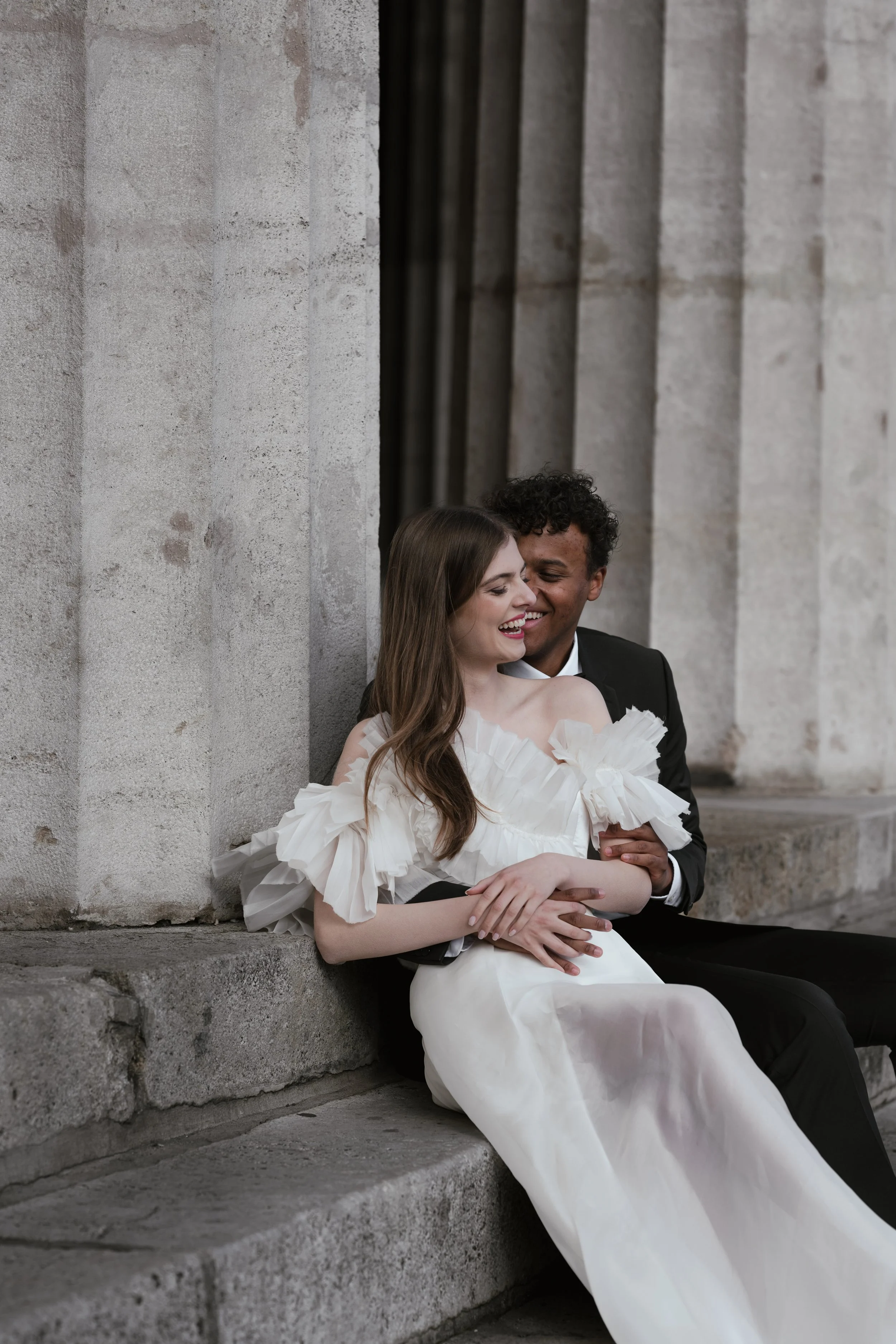 Bride sitting on stone steps – relaxed fine art bridal moment with quiet charm. fine art destination wedding photography