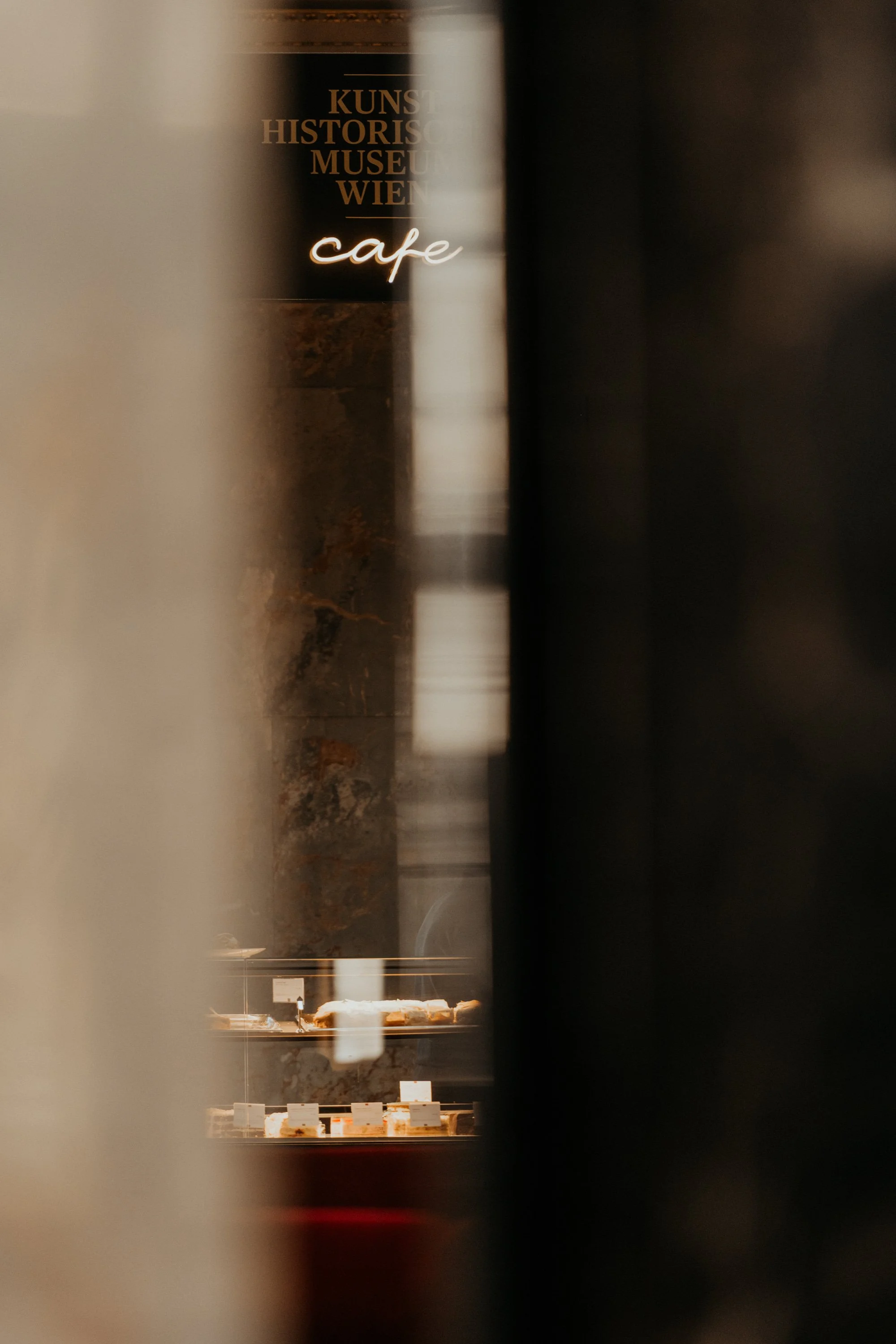 Golden café light and marble reflections – quiet fine art scene with Viennese flair.