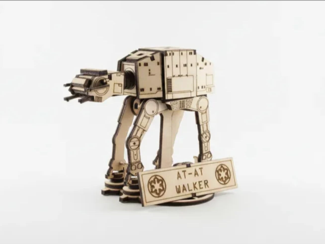 Wooden model of Star Wars AT-AT Walker with a sign reading 'AT-AT WALKER' in front.