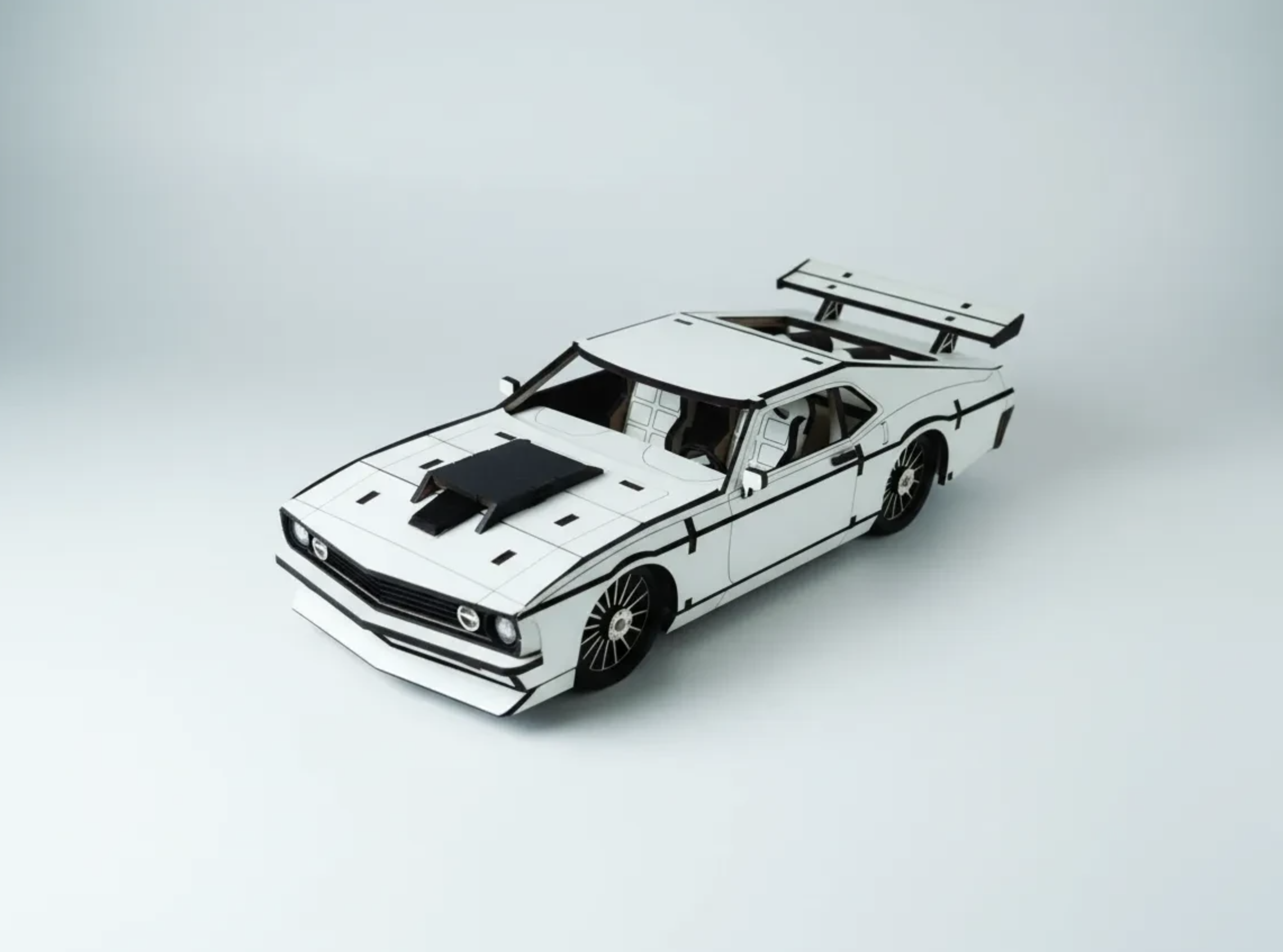 A white paper model race car with black outlines and details.