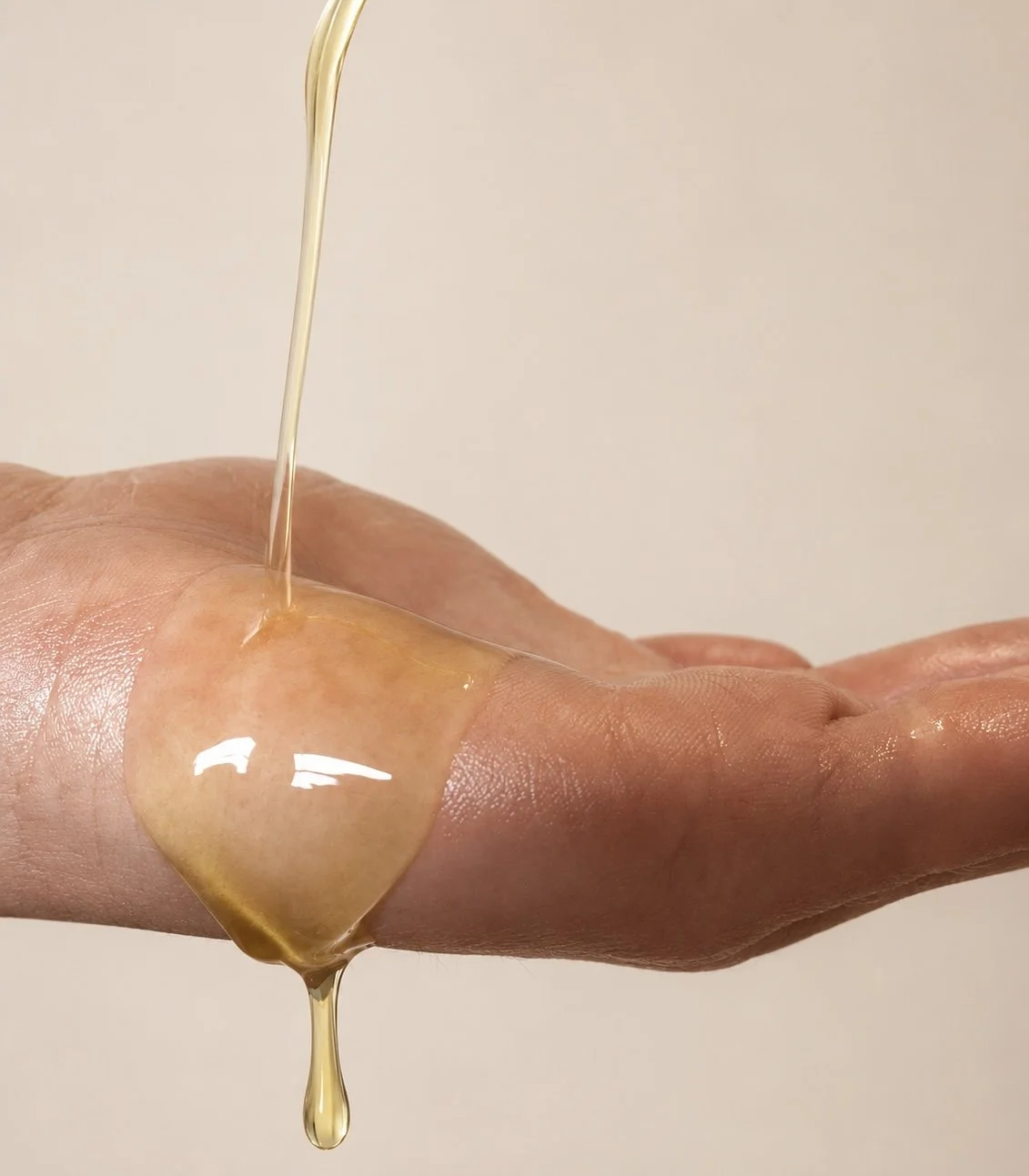 Body oil being poured in to hand.