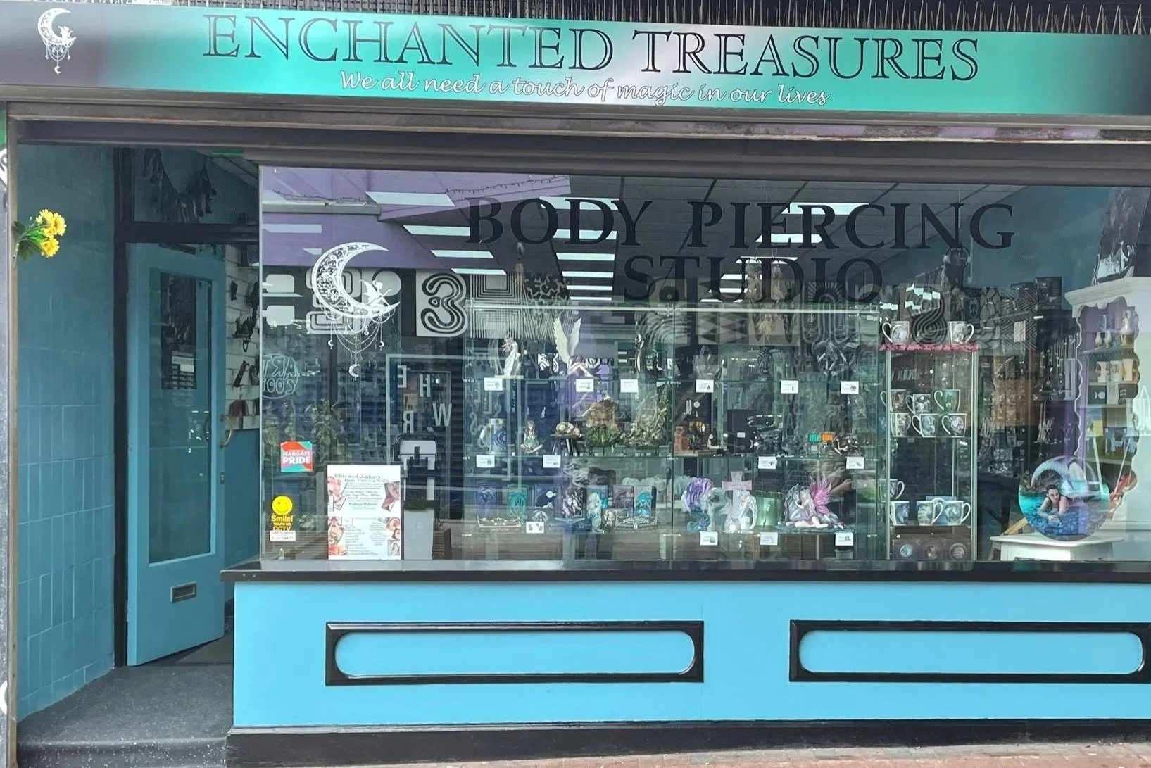 Welcome to the enchanting storefront of Enchanted Treasures, where we offer fun and friendly body piercing services! Our window display is filled with a delightful selection of jewellery and decorative items, just waiting for you to discover.