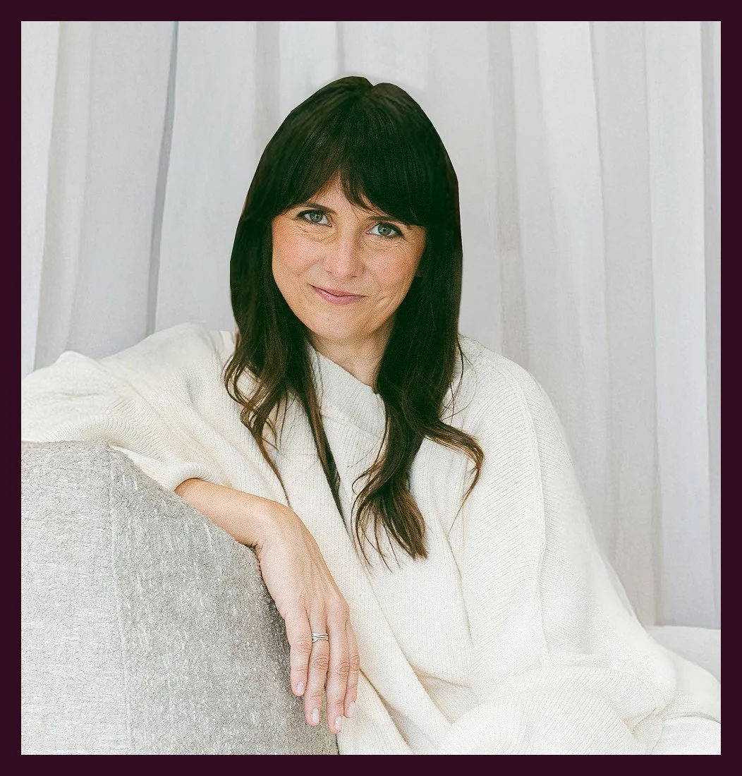 A woman wearing white and smiling.