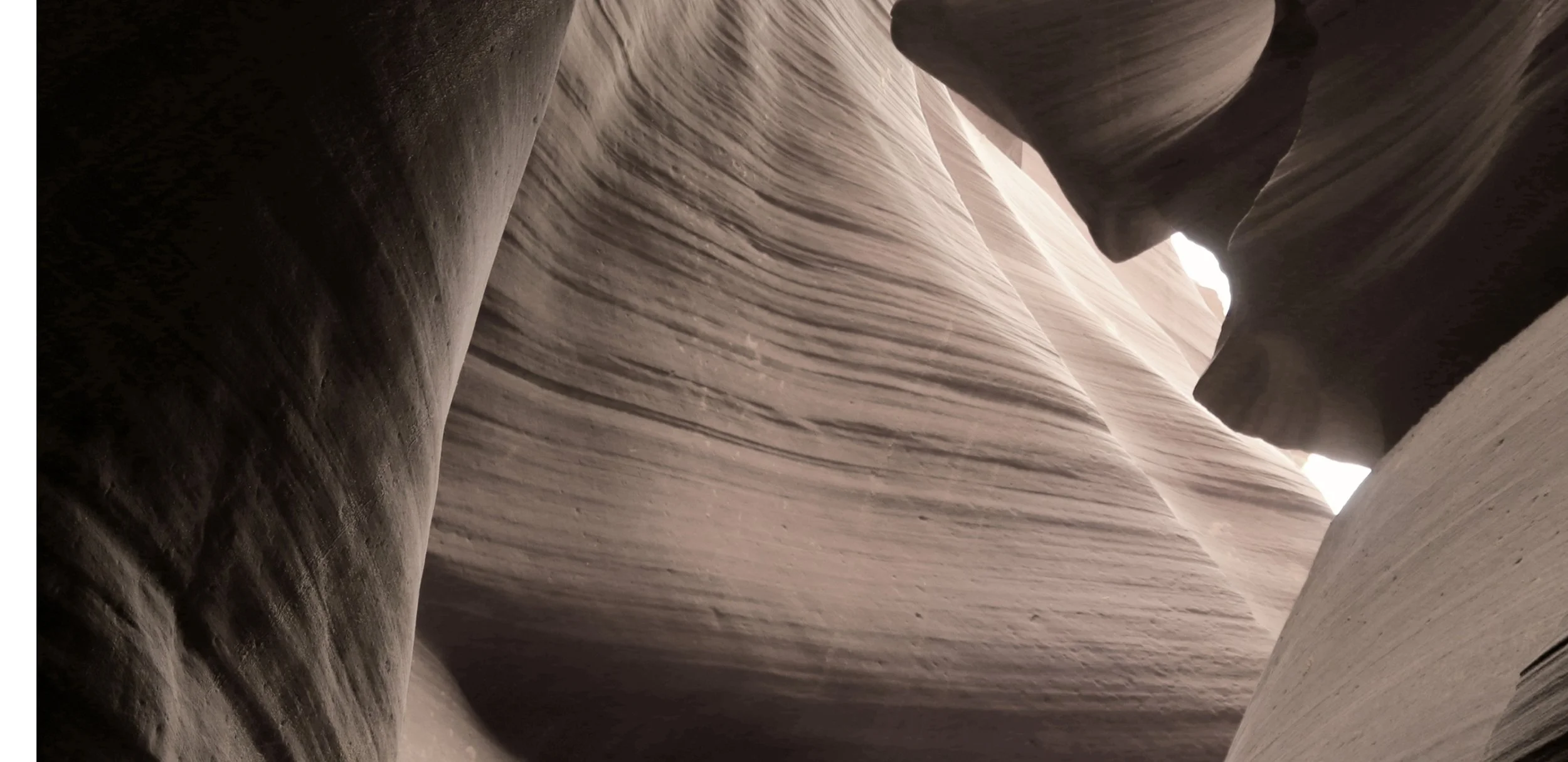 A narrow slot canyon with layered sandstone walls.