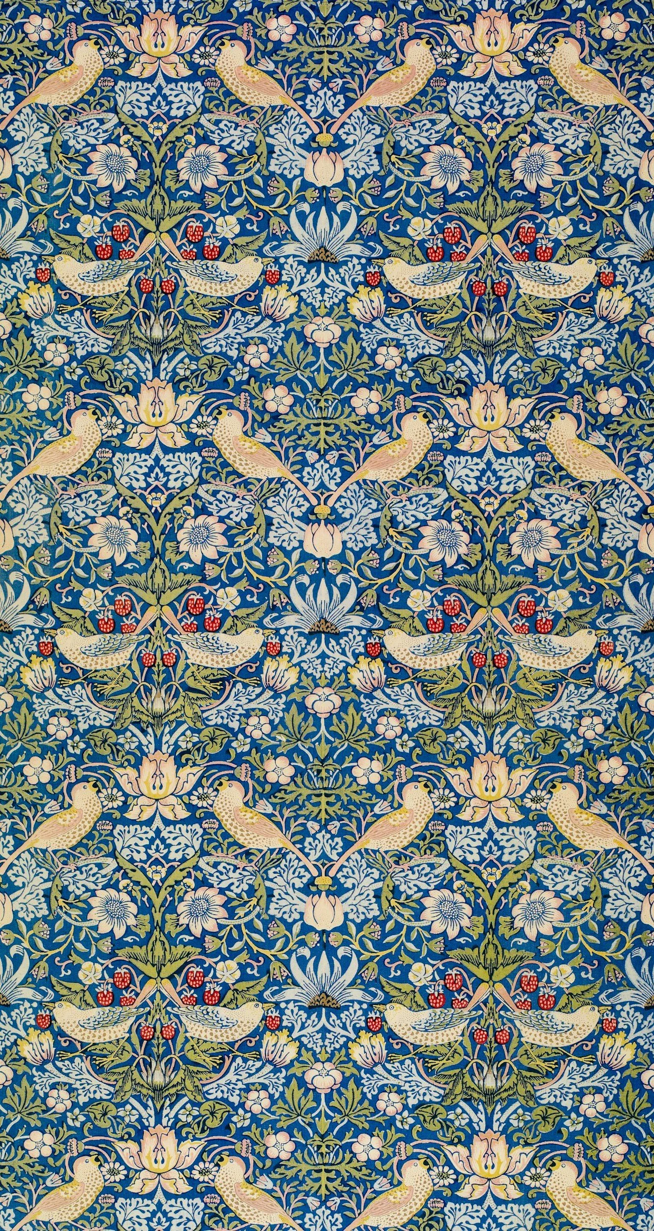 A detailed, decorative pattern featuring symmetrical arrangements of birds, flowers, and leaves in pastel shades on a dark blue background, reminiscent of William Morris textile designs.