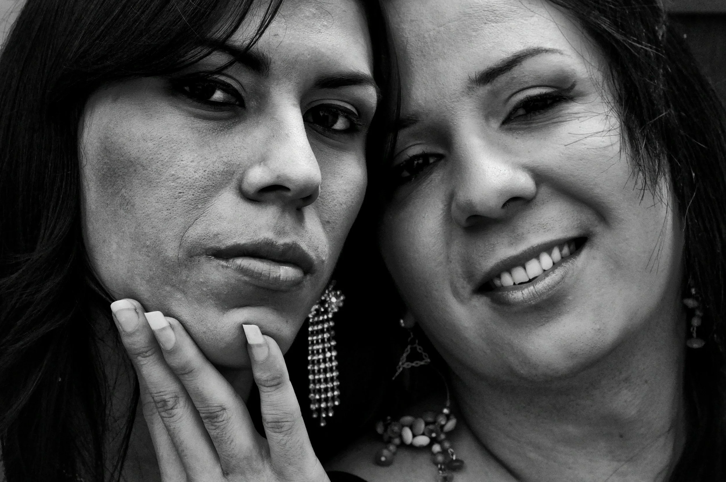 Black and white photo of two smiling women representing LGBTQ+ inclusion and belonging